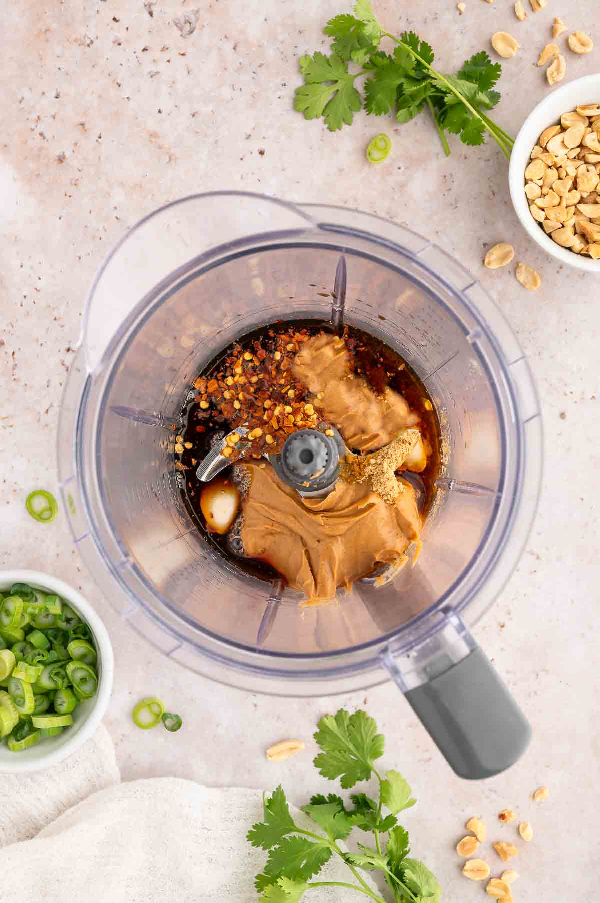Ingredients for the peanut sauce added to a food processor.