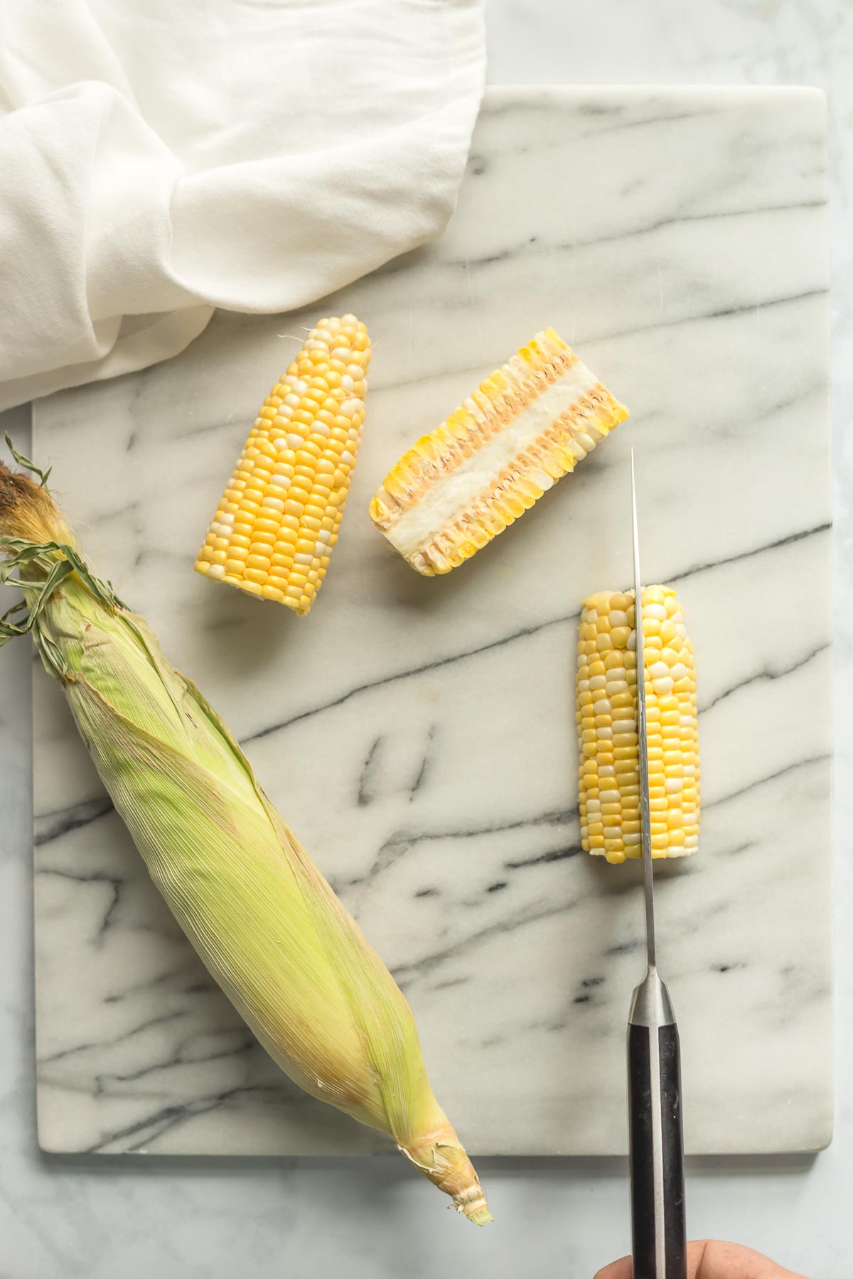 Corn cobs being cut and prepped.