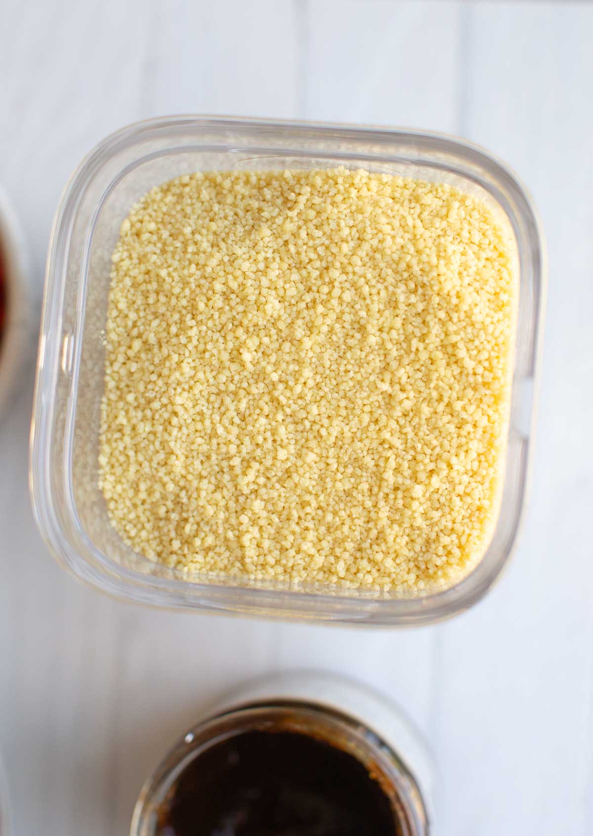 A container filled with dry instant couscous.