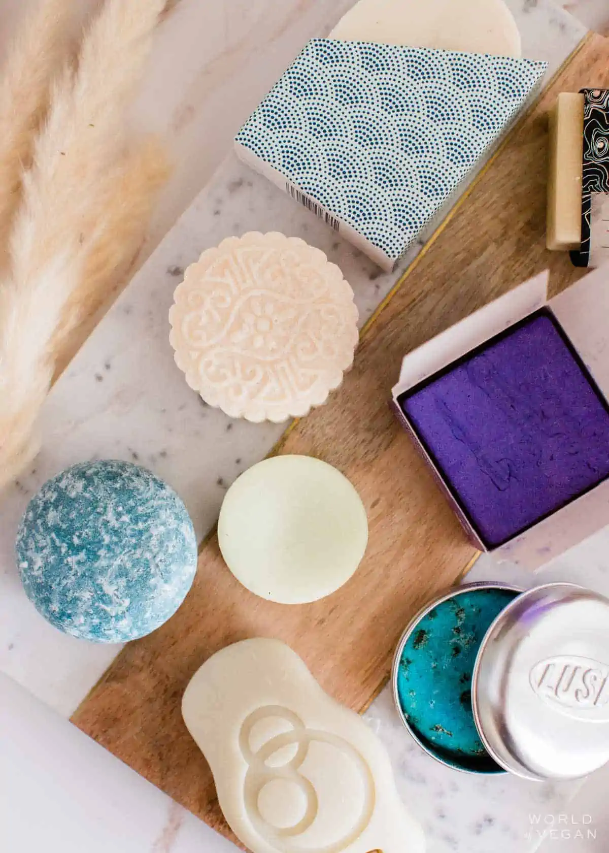 A collection of vegan cruelty-free eco-friendly shampoo bars laid out on a table.