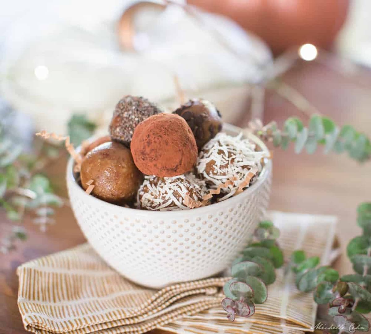 Date truffle cookie dough balls arranged in a bowl.