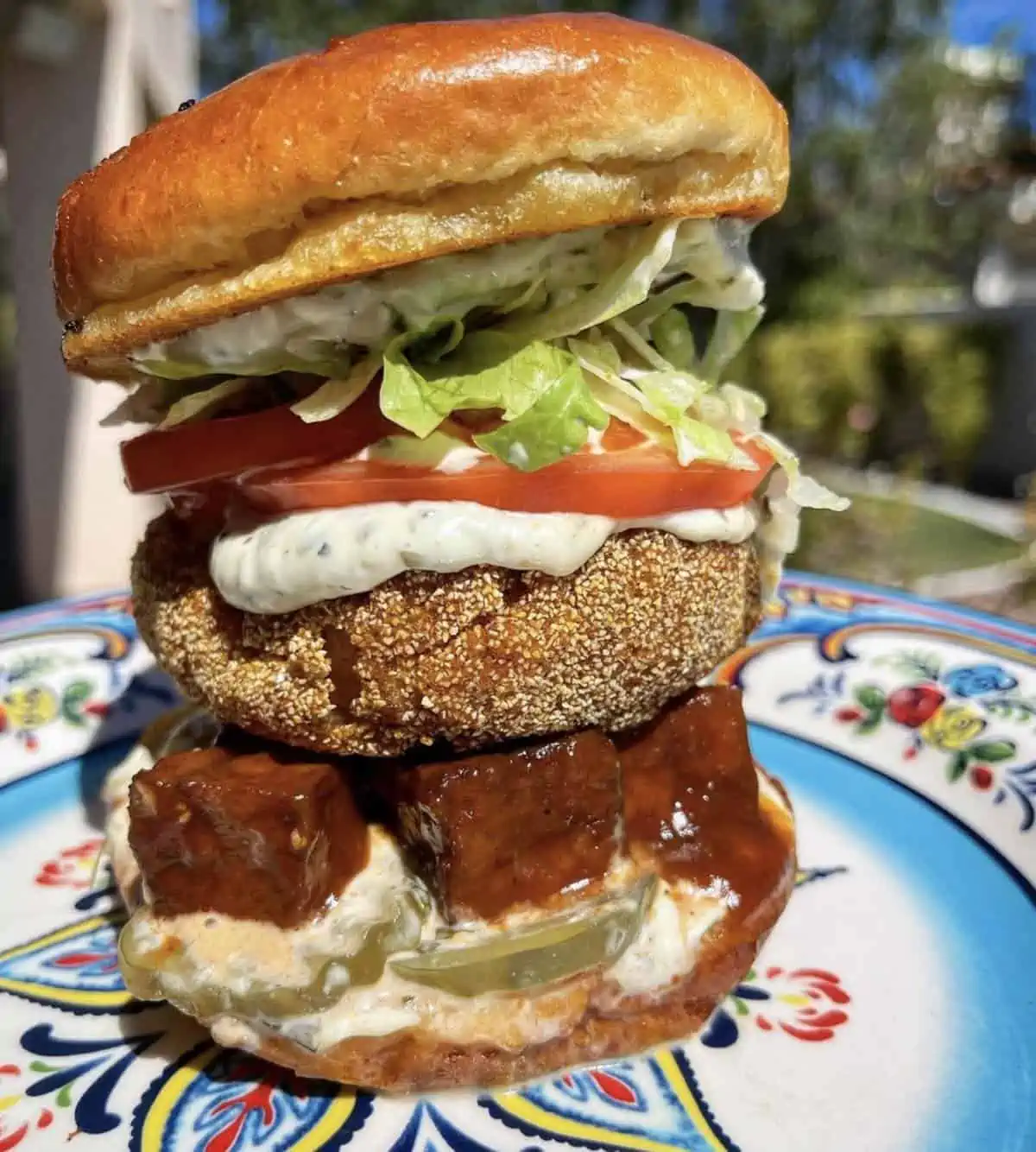 Epic vegan fried chicken sandwich stacked with bbq tofu and more from Souley Vegan in Oakland, CA.