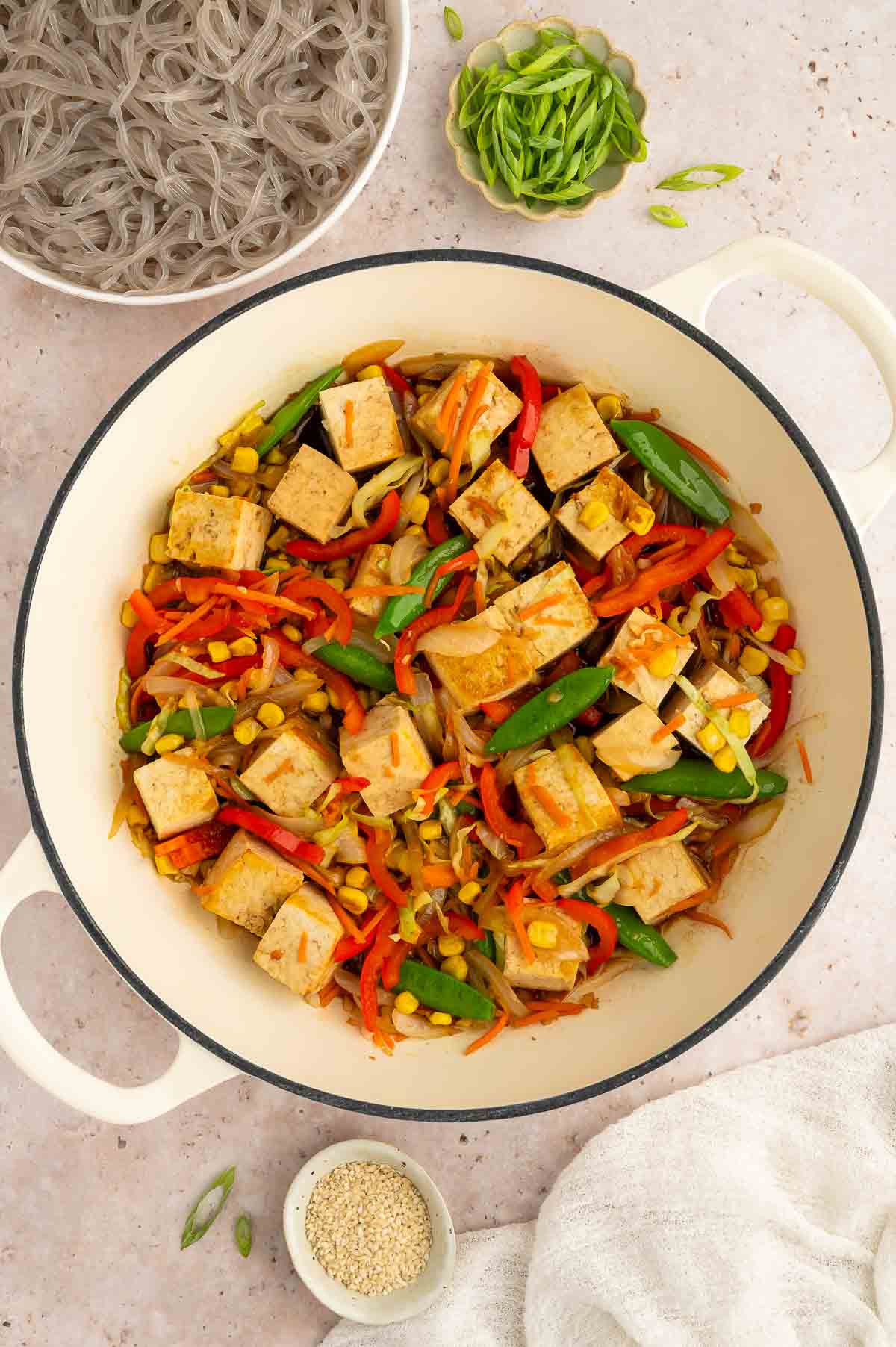 A pan with cubed tofu and red bell pepper.