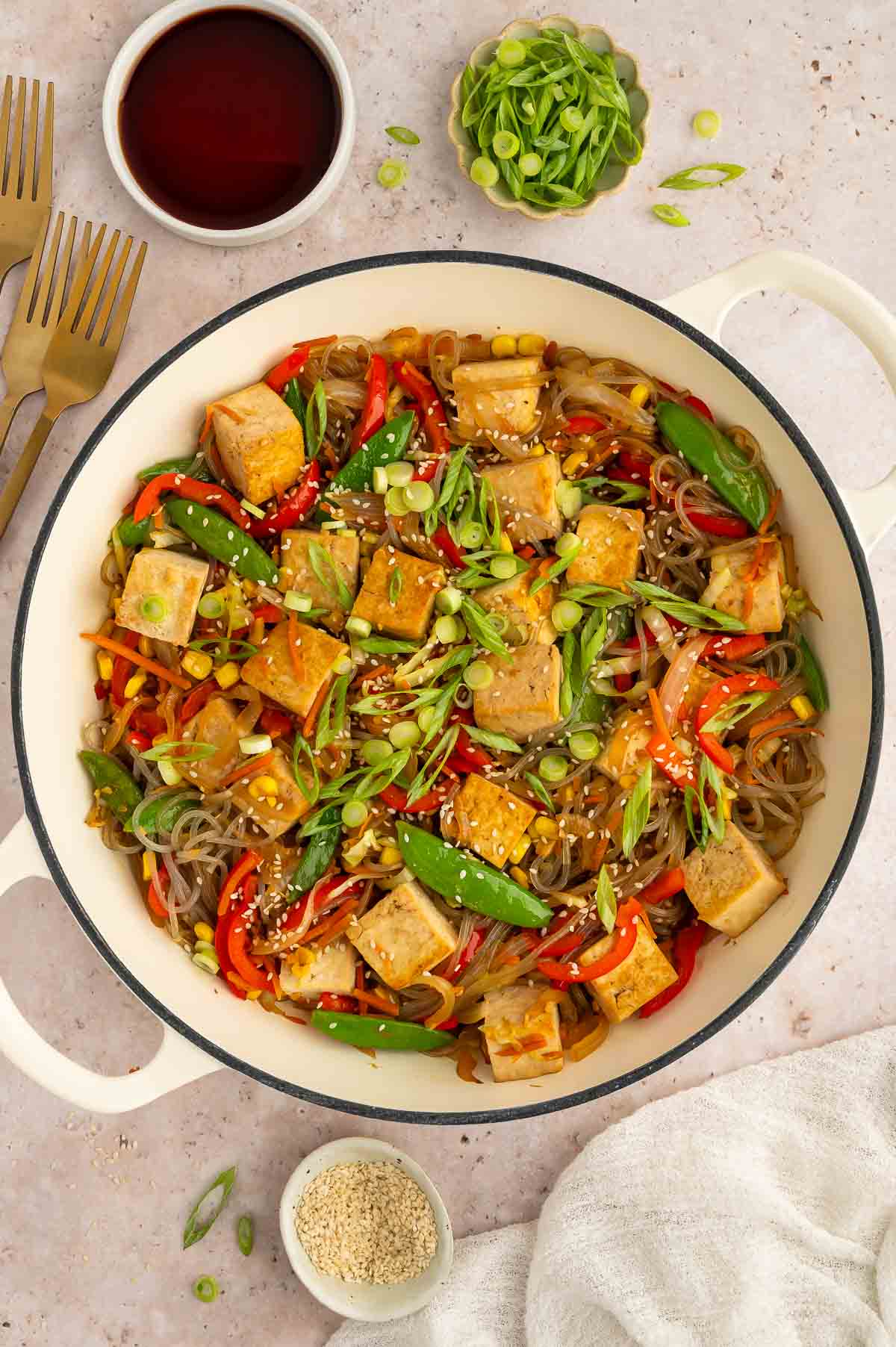 A tofu glass noodle veggie dish with garnish.