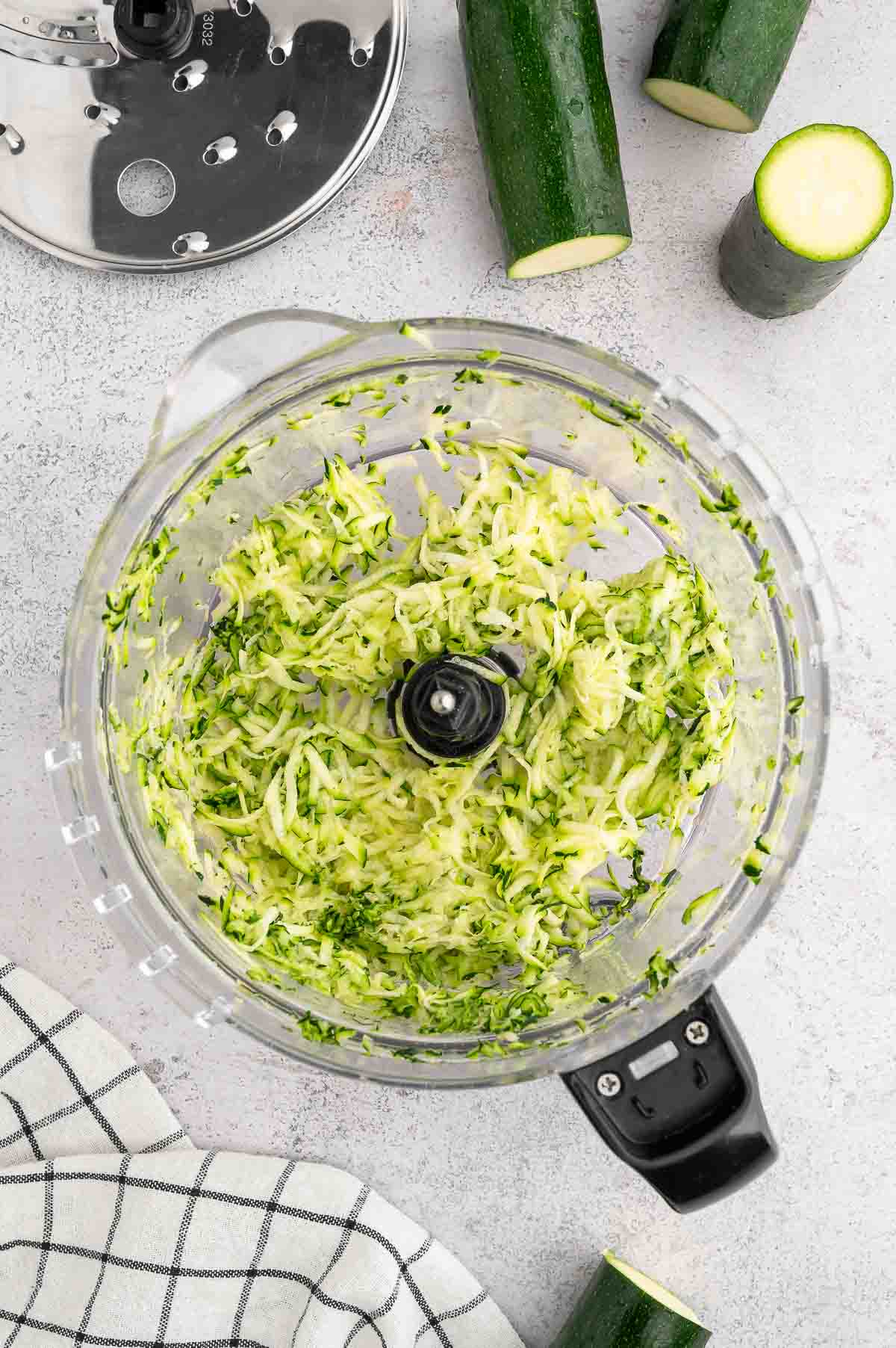 Grated zucchini in a food processor.