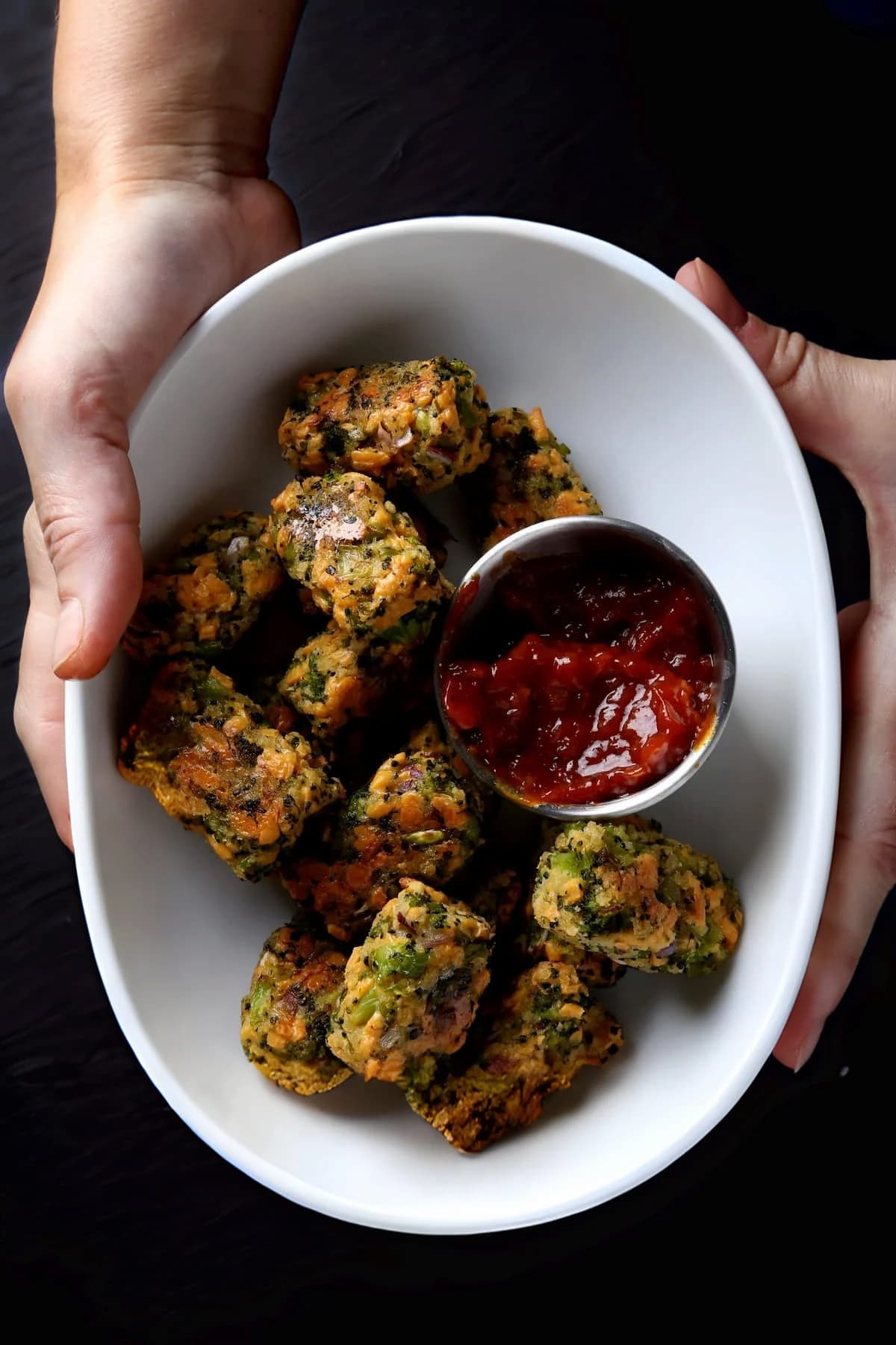 A bowl of broccoli tots, a healthy, wholesome vegan snack.