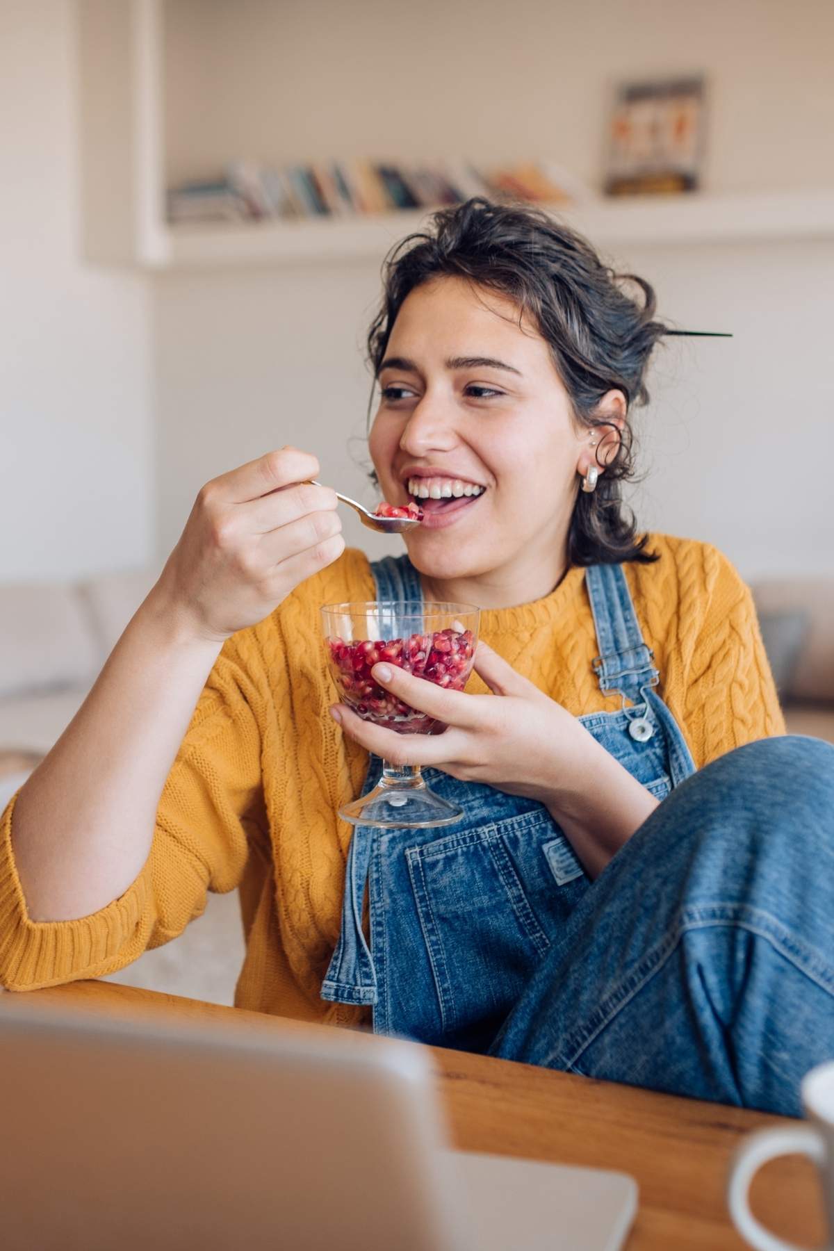 A person eating a healthy vegan snack of fruit.