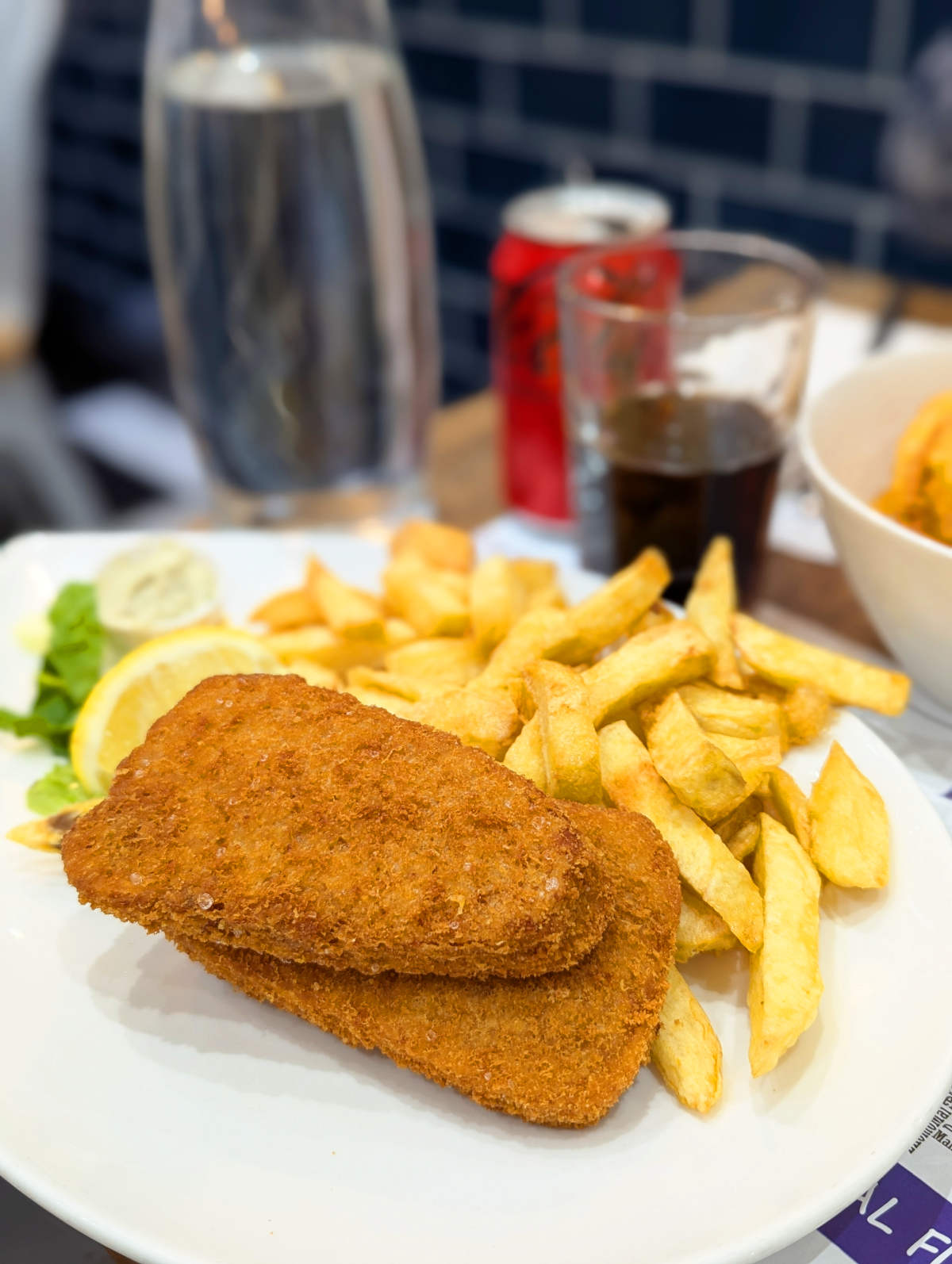 Battered vegan fish and chips on a plate at Hobson's in London.