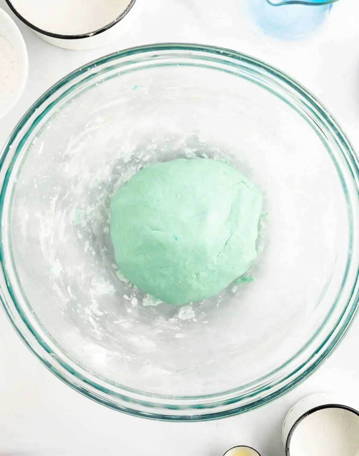 Playdough recipe in mixing bowl after it's been fully mixed into a smooth ball.