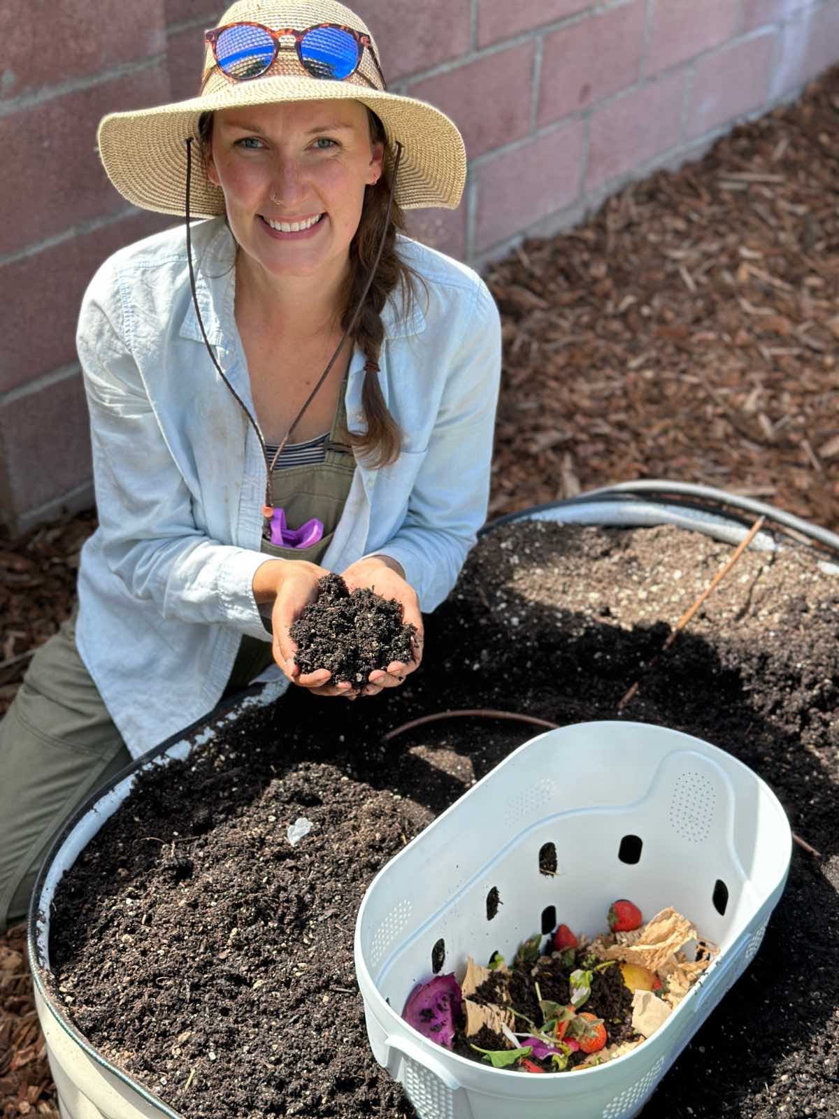 Jenn MacLeod of Sunflower & Sage Gardens installing an in-bed worm compost bin from Vego Garden.