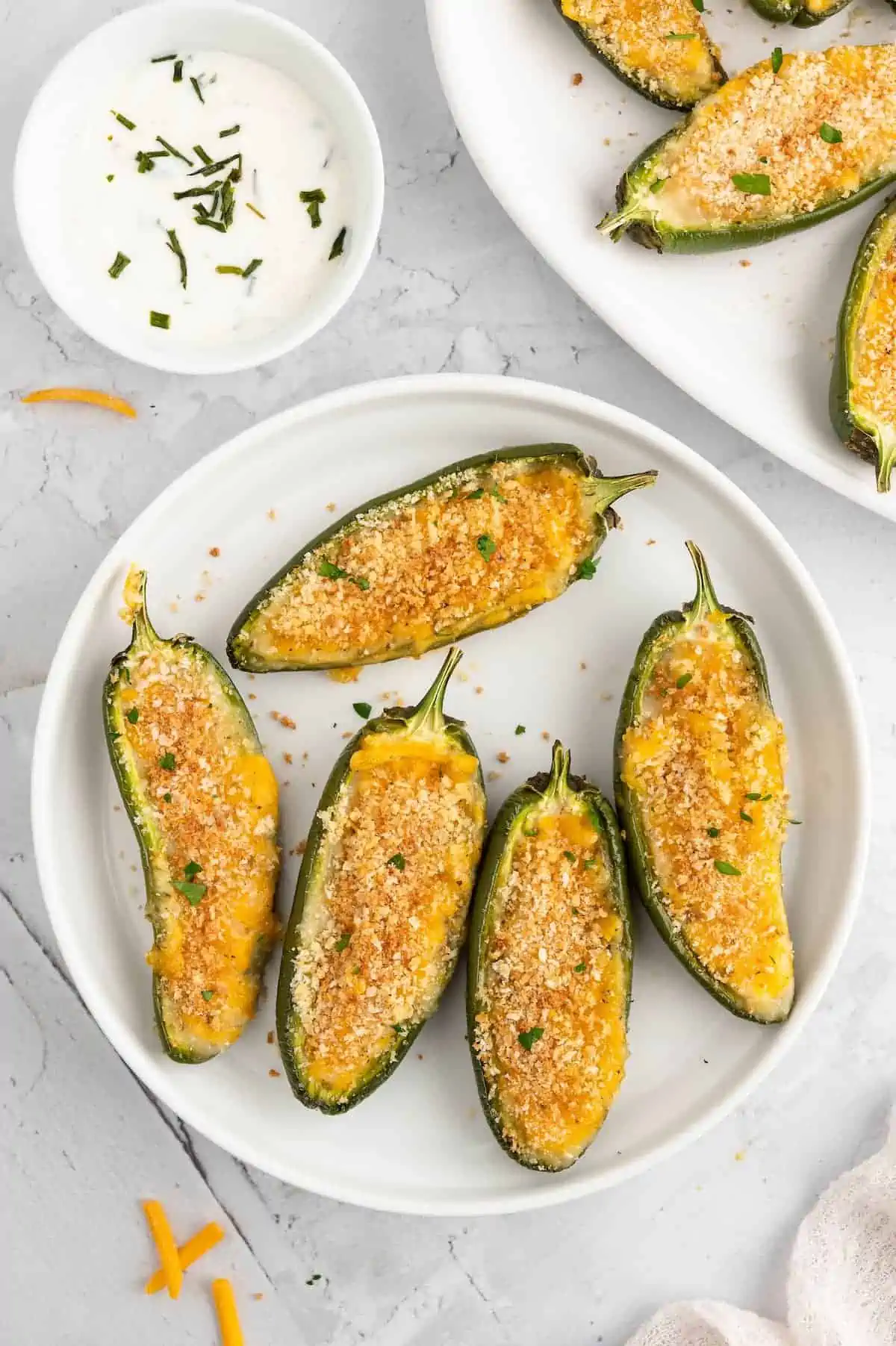 Crispy vegan jalapeño poppers served hot, filled with dairy-free cheese and crunchy breadcrumb coating.