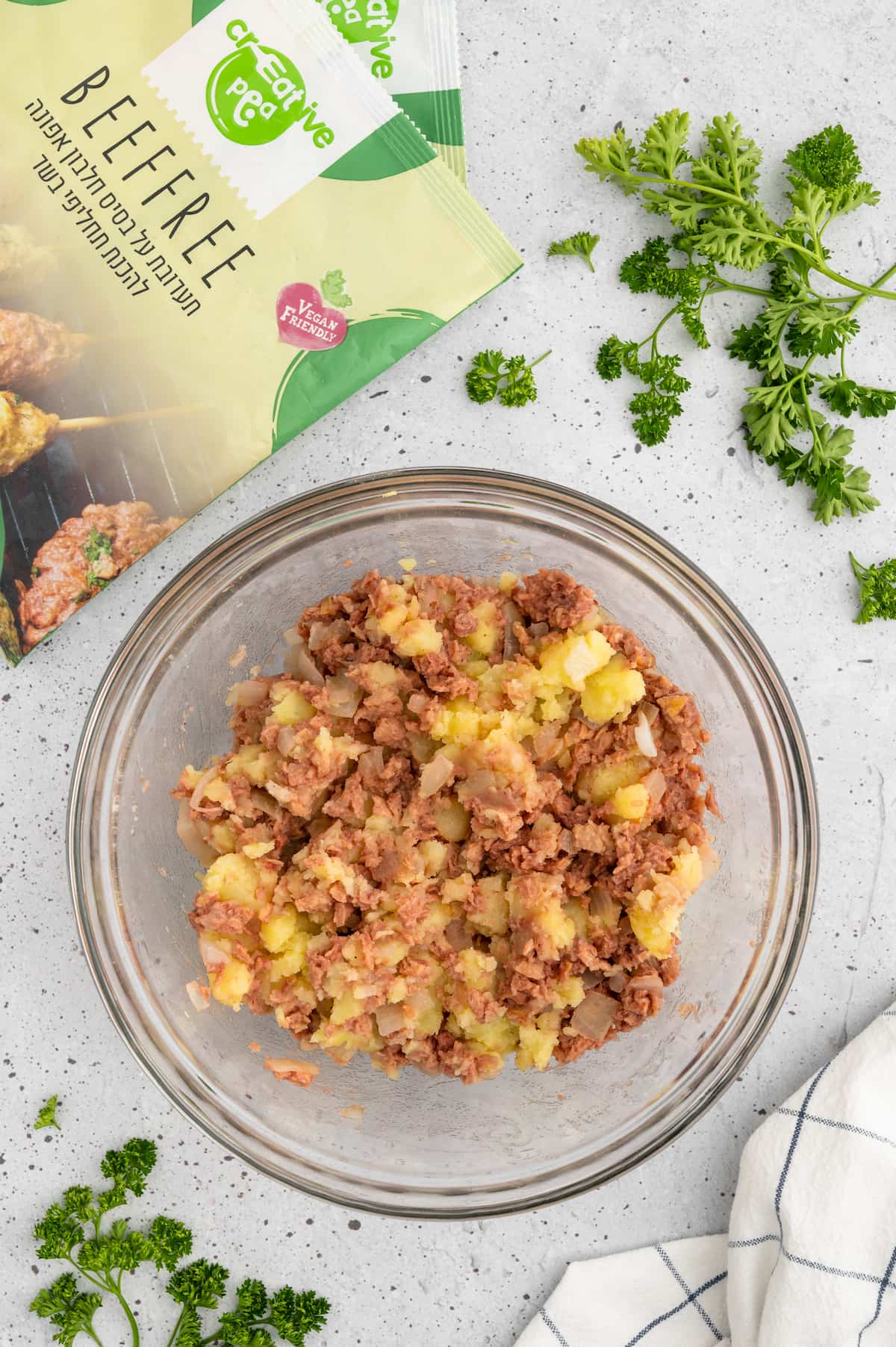 Caramelized onions and vegan ground beef added to the bowl of mashed potatoes.