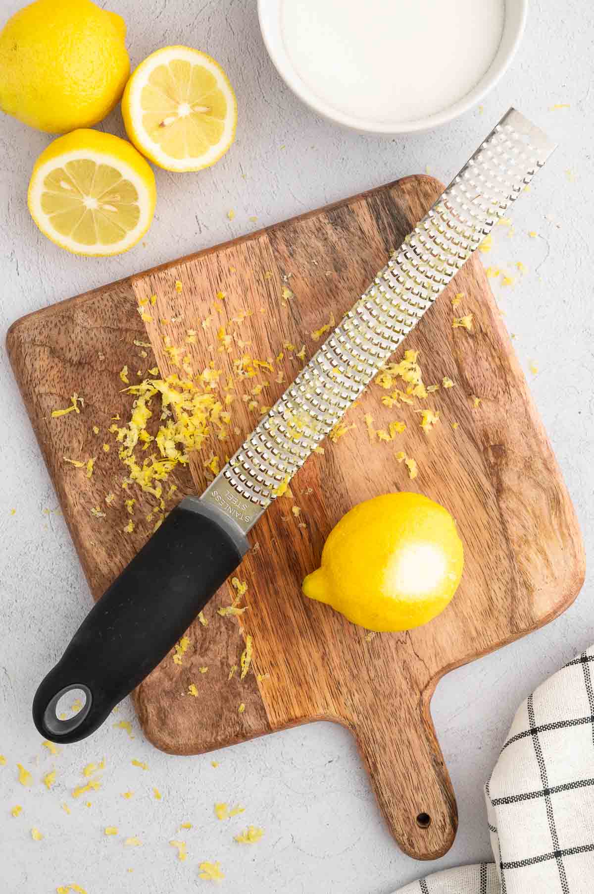 A lemon zested on a cutting board.