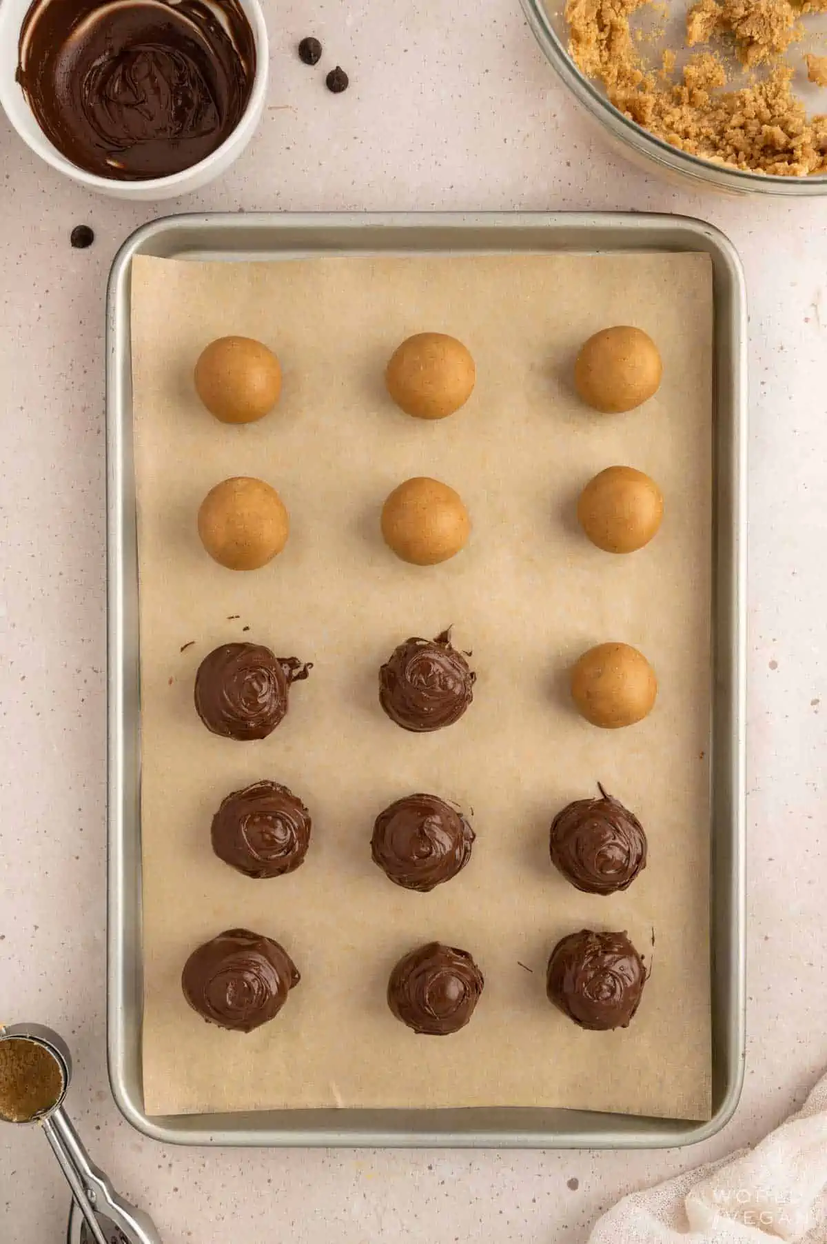 Peanut butter cookie dough rolled into balls and dipped in melted dairy-free chocolate to make bonbons.