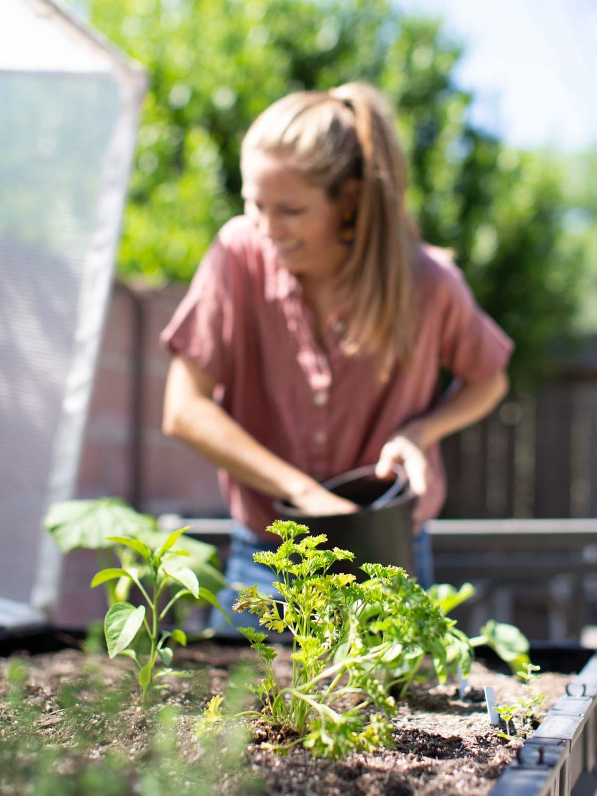 Michelle Cehn, in her garden with fresh greenery.