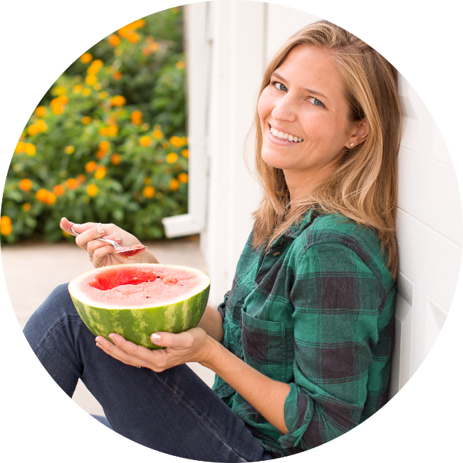 Headshot portrait photo of World of Vegan founder Michelle Cehn eating watermelon.