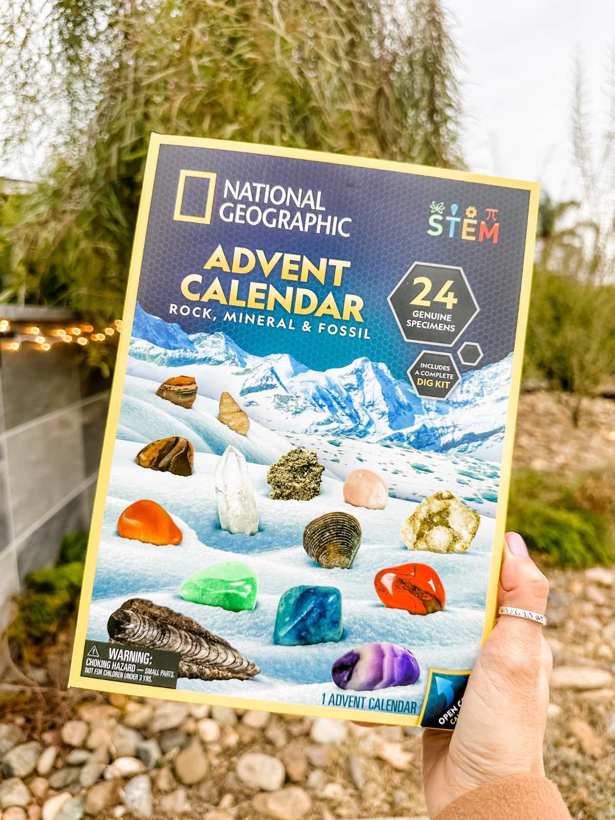 Holding out the National Geographic advent calendar with gemstones.