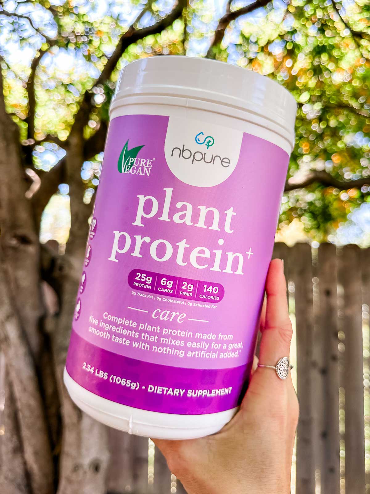 A canister of NBPure brand plant-based protein powder.