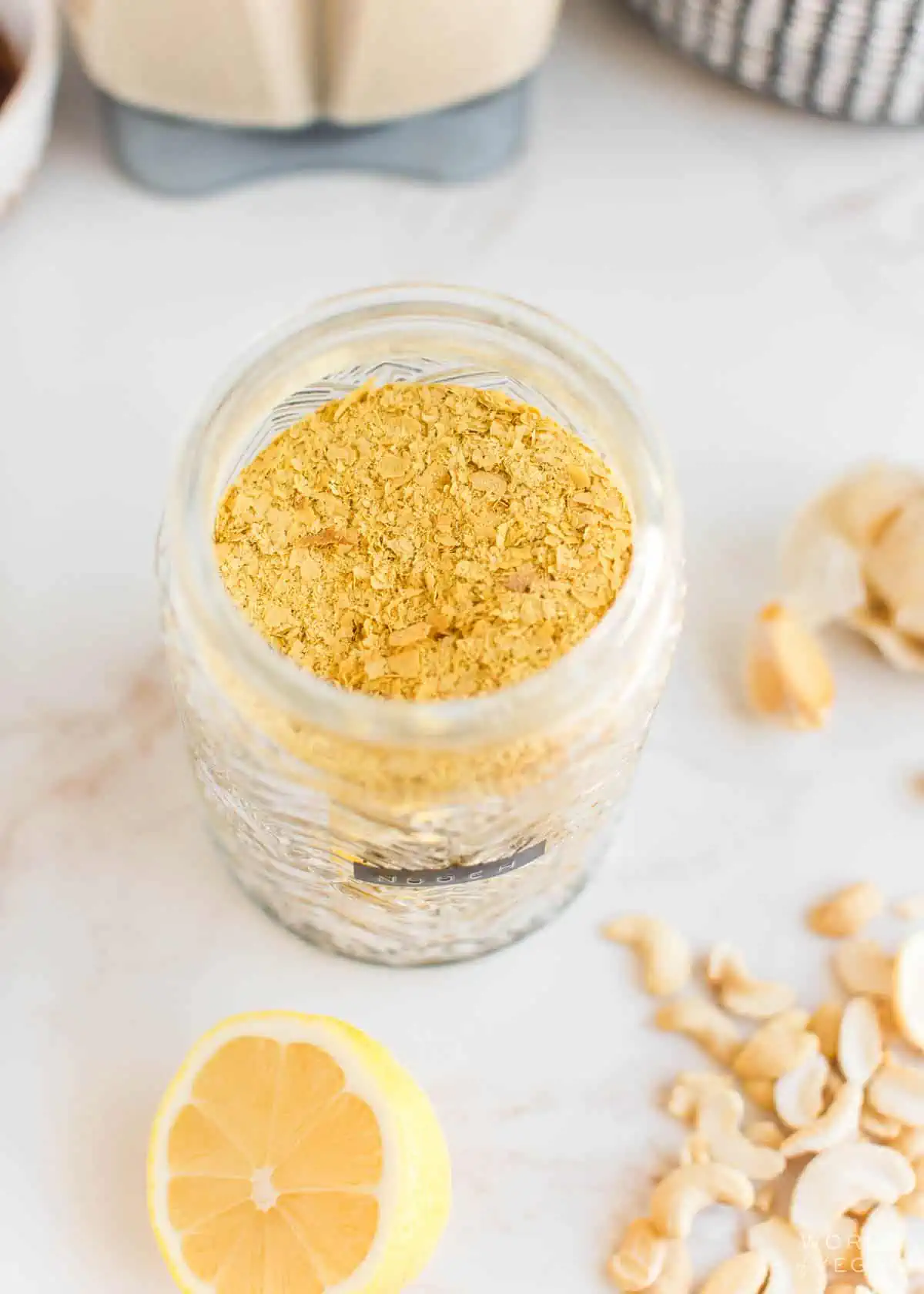 Nutritional yeast, one of the most simple yet important vegan pantry essentials, in a jar.