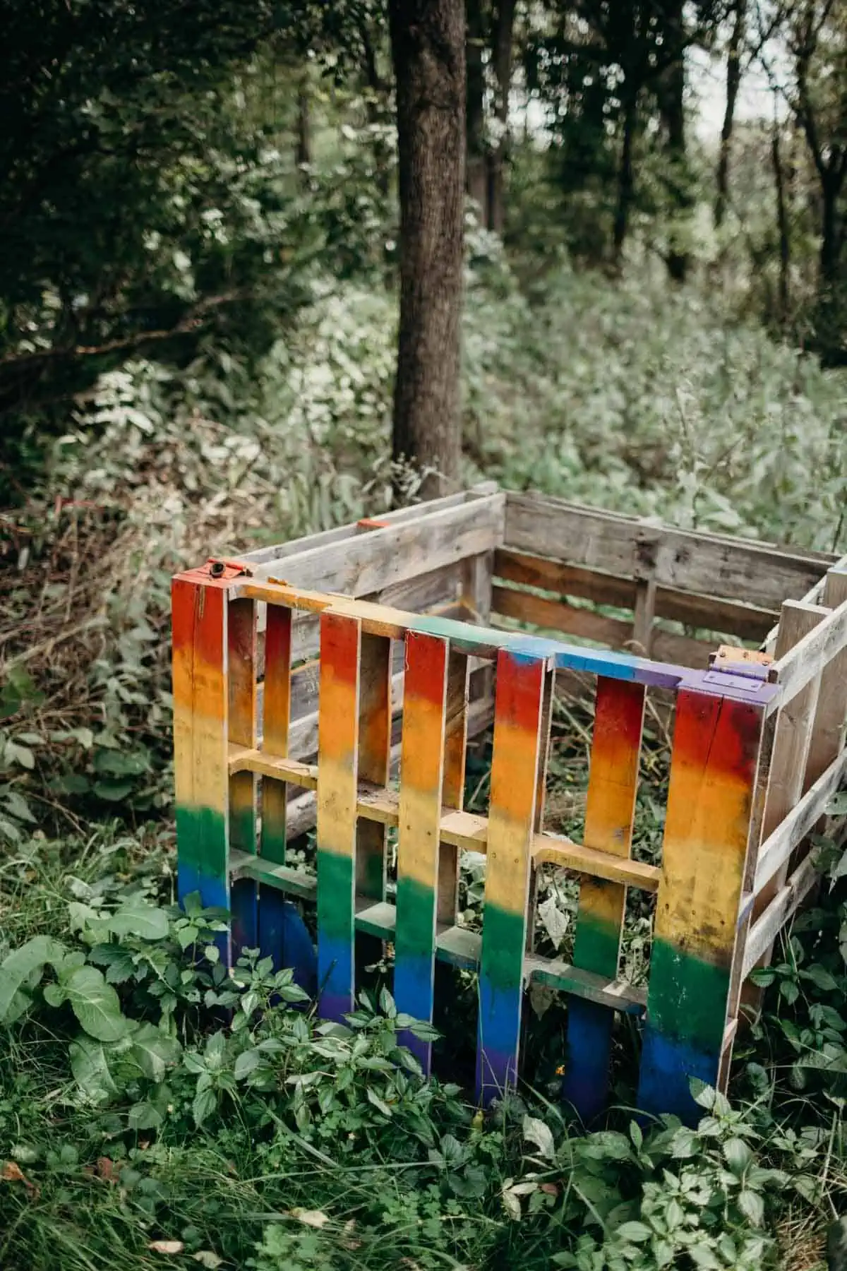 Rainbow-painted compost bin for a low-waste vegan wedding.