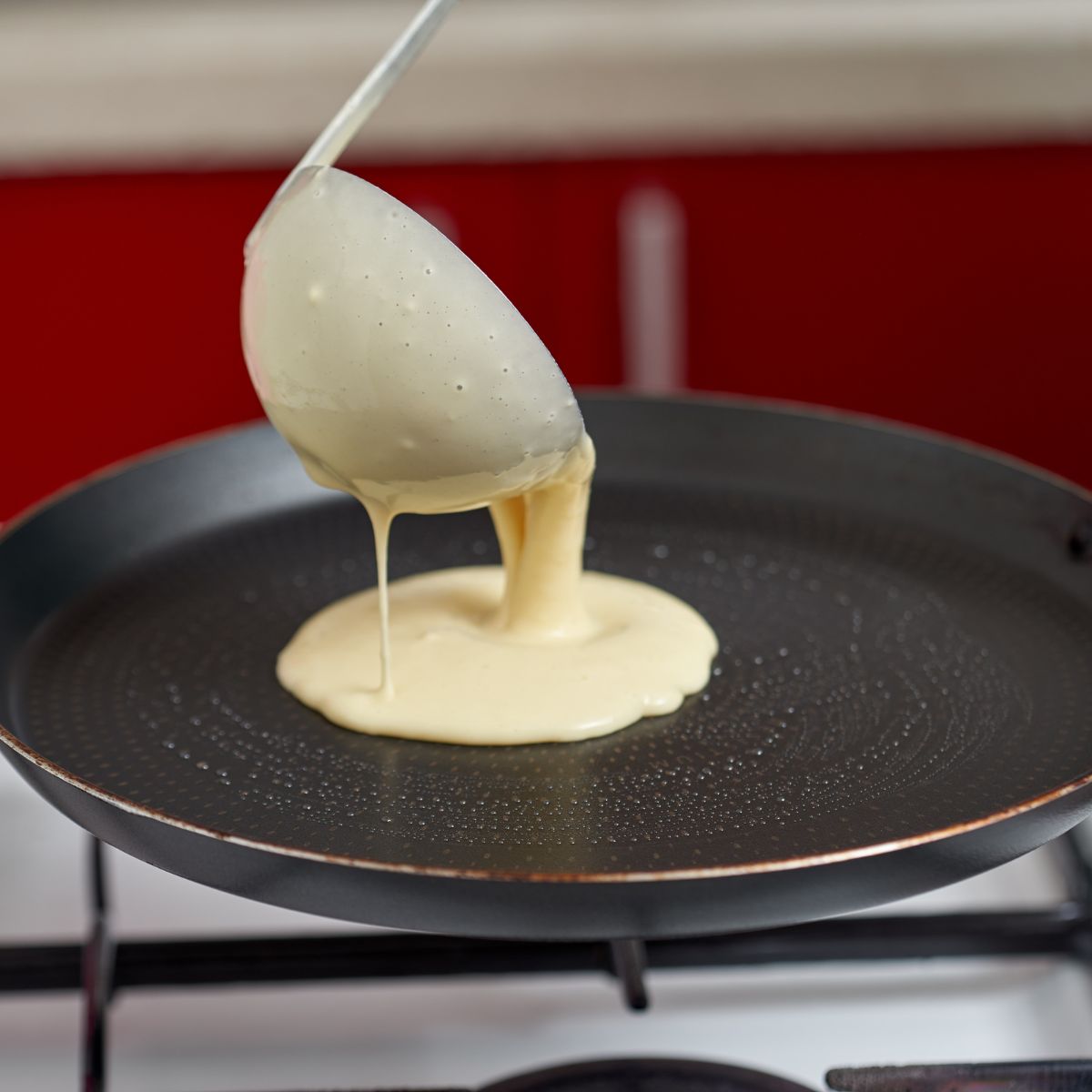Pancake batter spooned over a hot griddle.