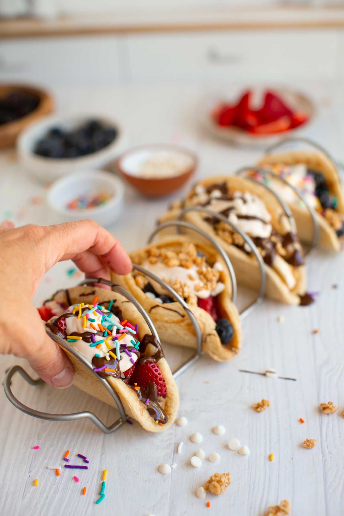 A hand reaching for a pancake taco.