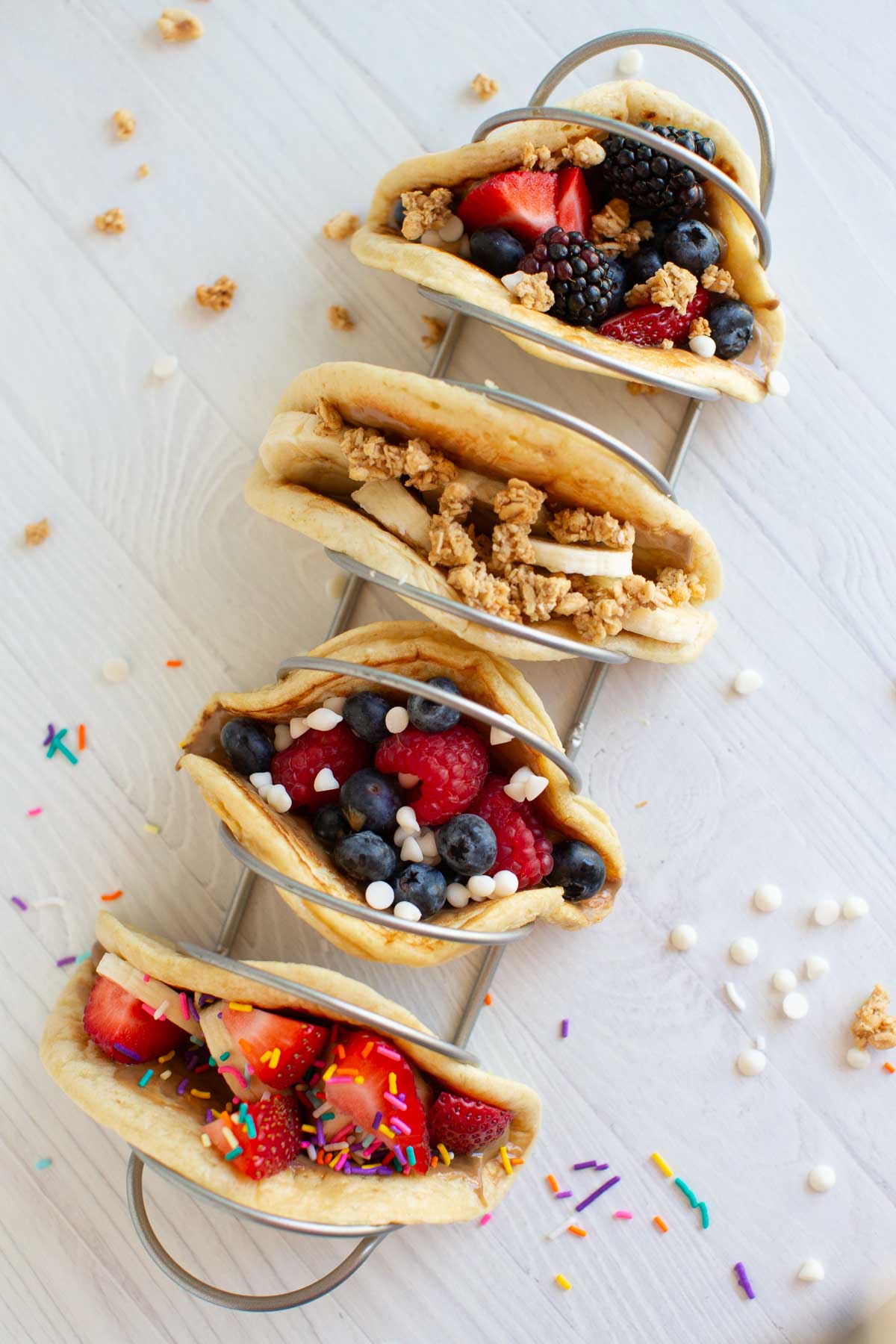 A row of pancake tacos with different toppings.