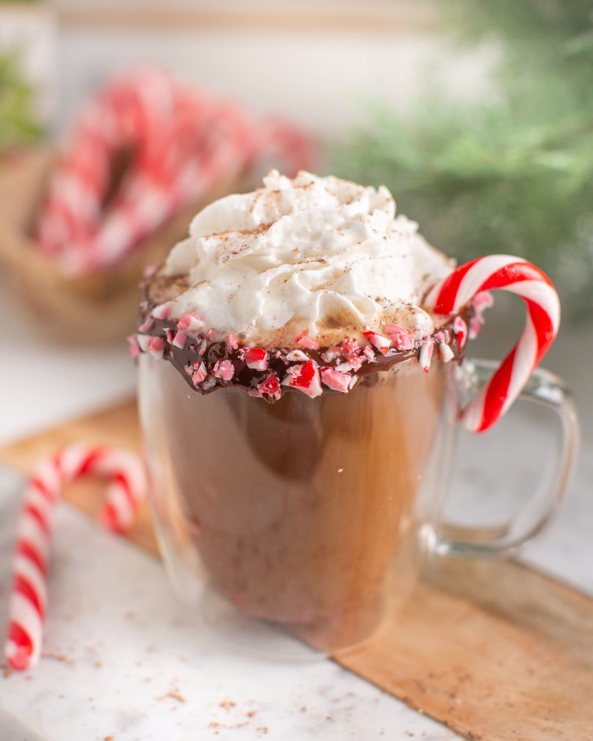 A mug of vegan peppermint mocha with a candy cane.