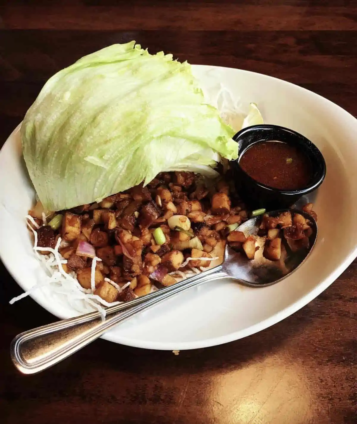 The vegan lettuce wraps served on a white plate at PF Changs.