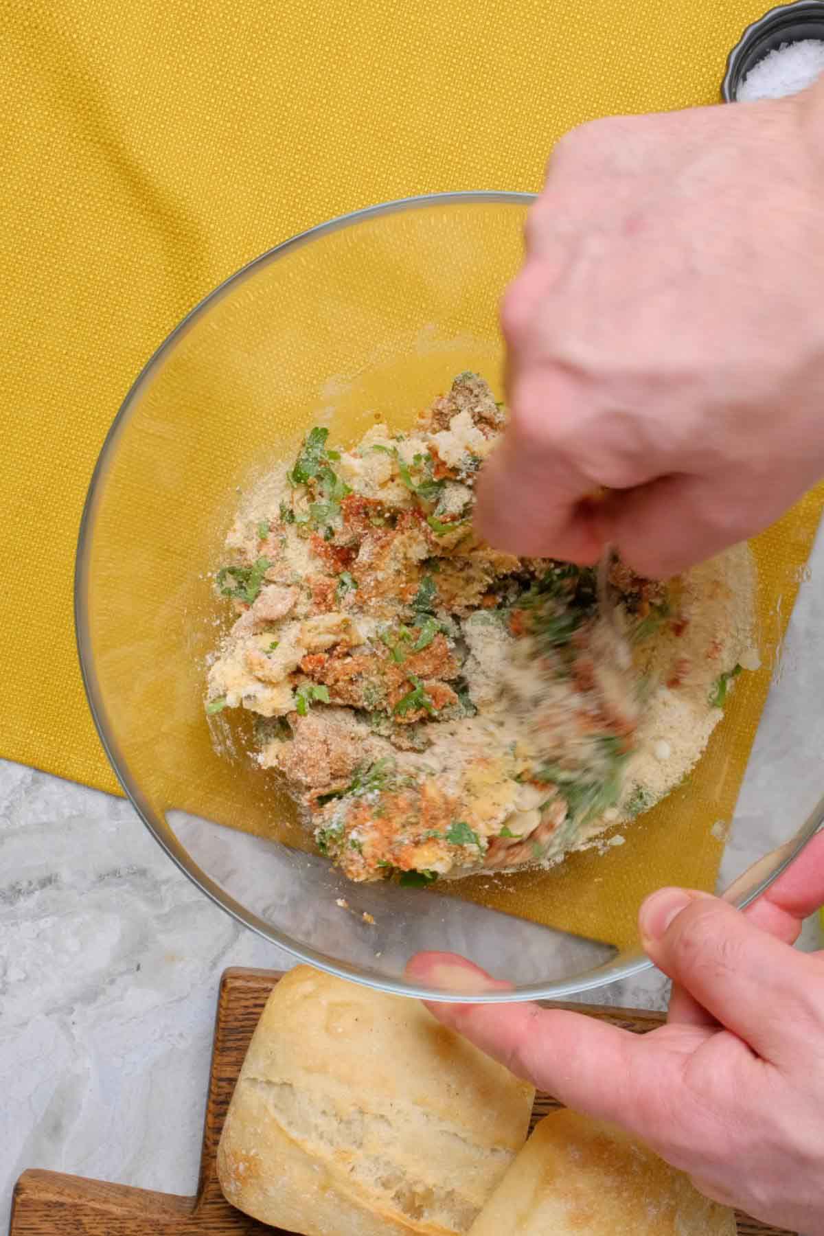 A pizza burger mixture being mashed with a fork.