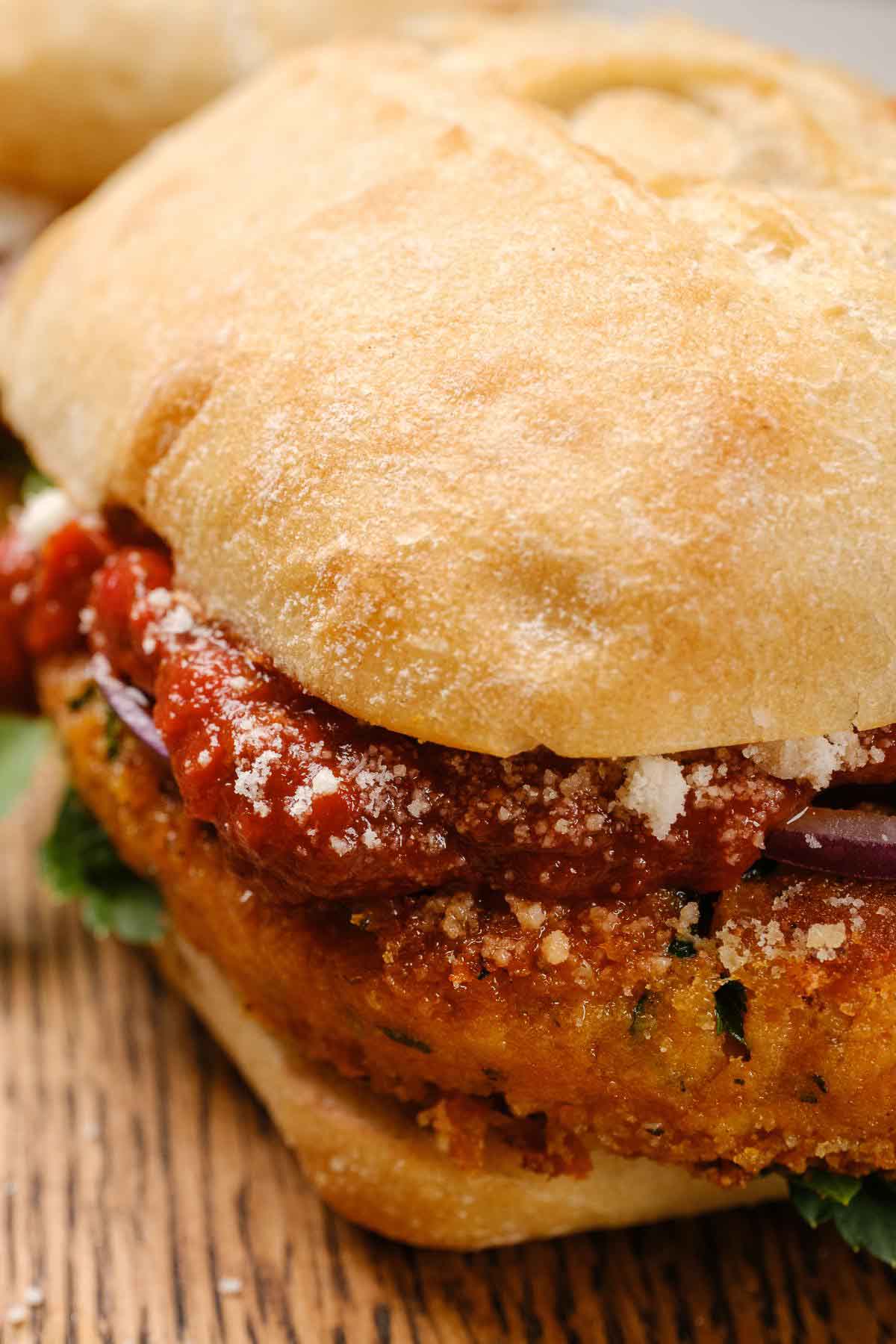 A pizza burger with marinara sauce.