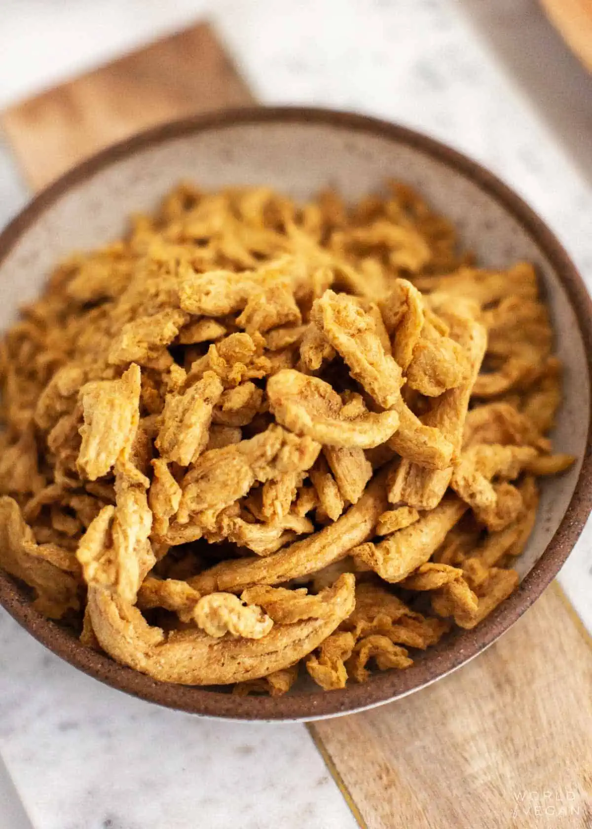 Plain dehydrated soy curls in a rustic dish.