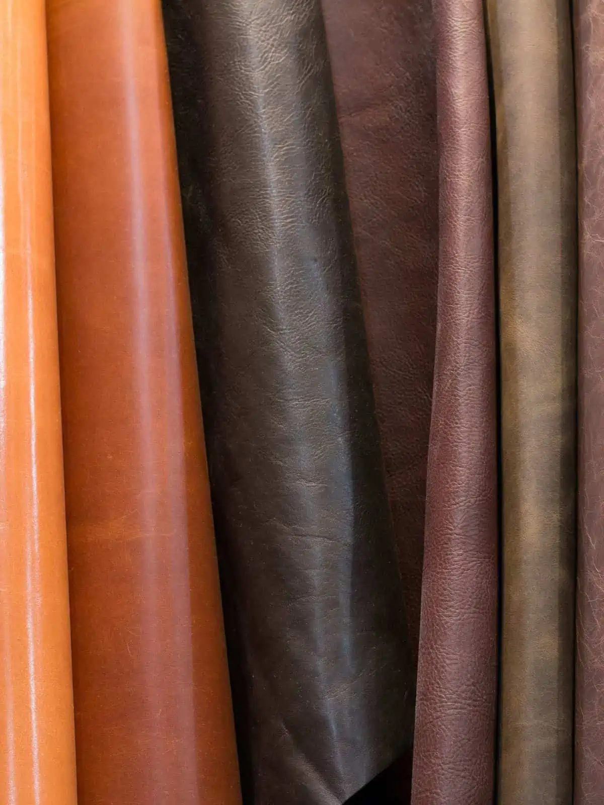 Polyurethane leather pieces in several shades of dark and light brown colors.