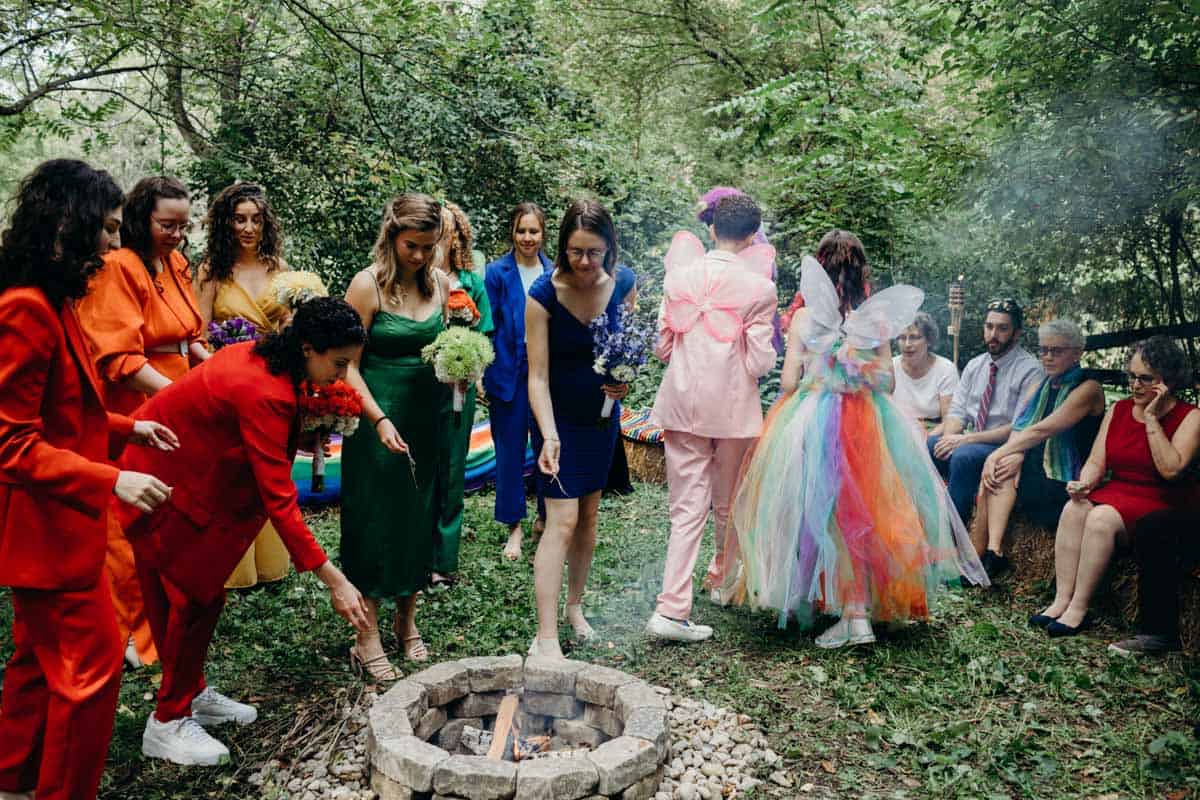 Rainbow woodland wedding bon fire outdoors.