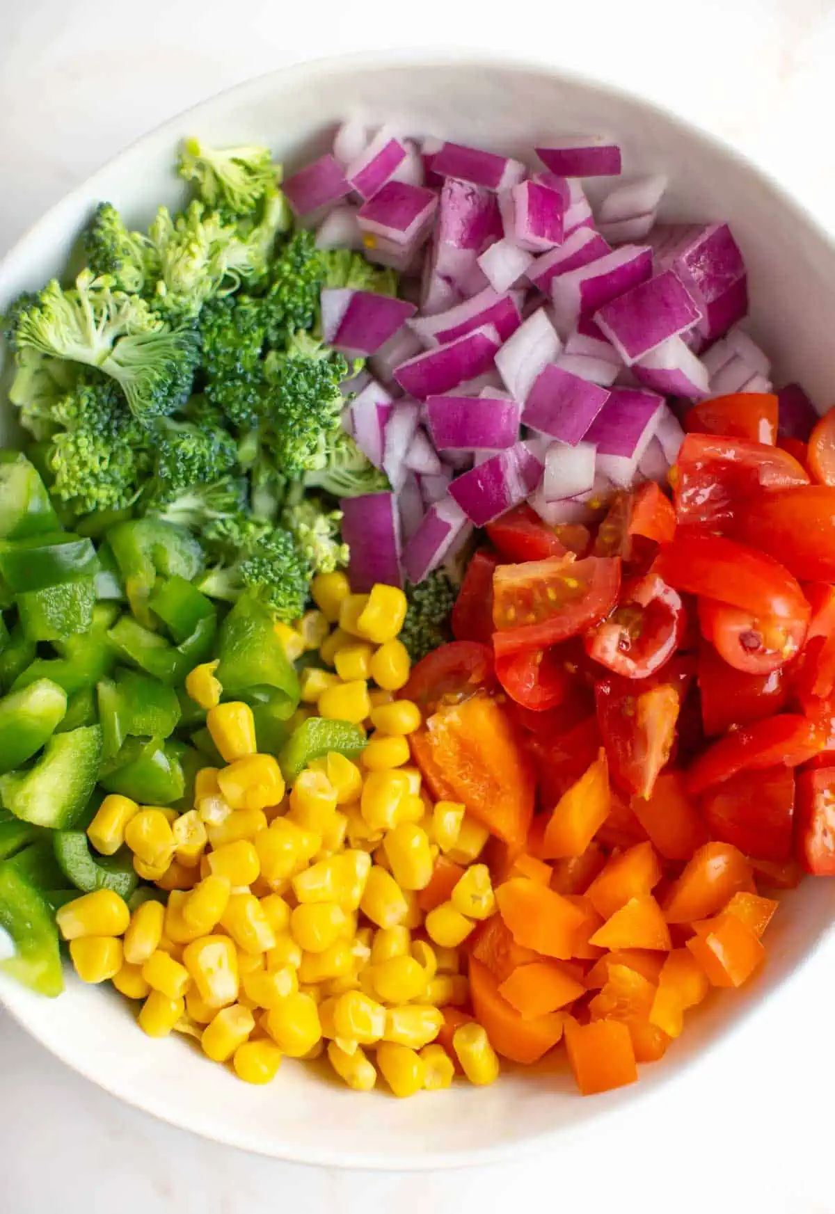 Bowl of diced veggies to use on rainbow pizza.