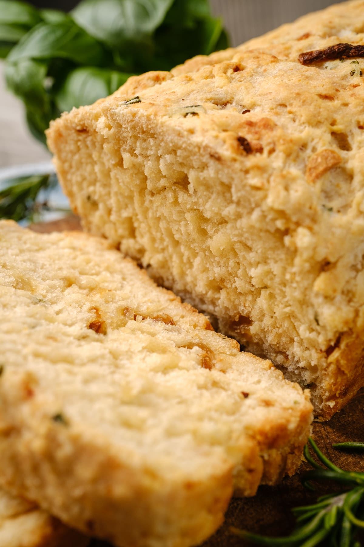 Rosemary bread loaf sliced, displaying the crumb texture.