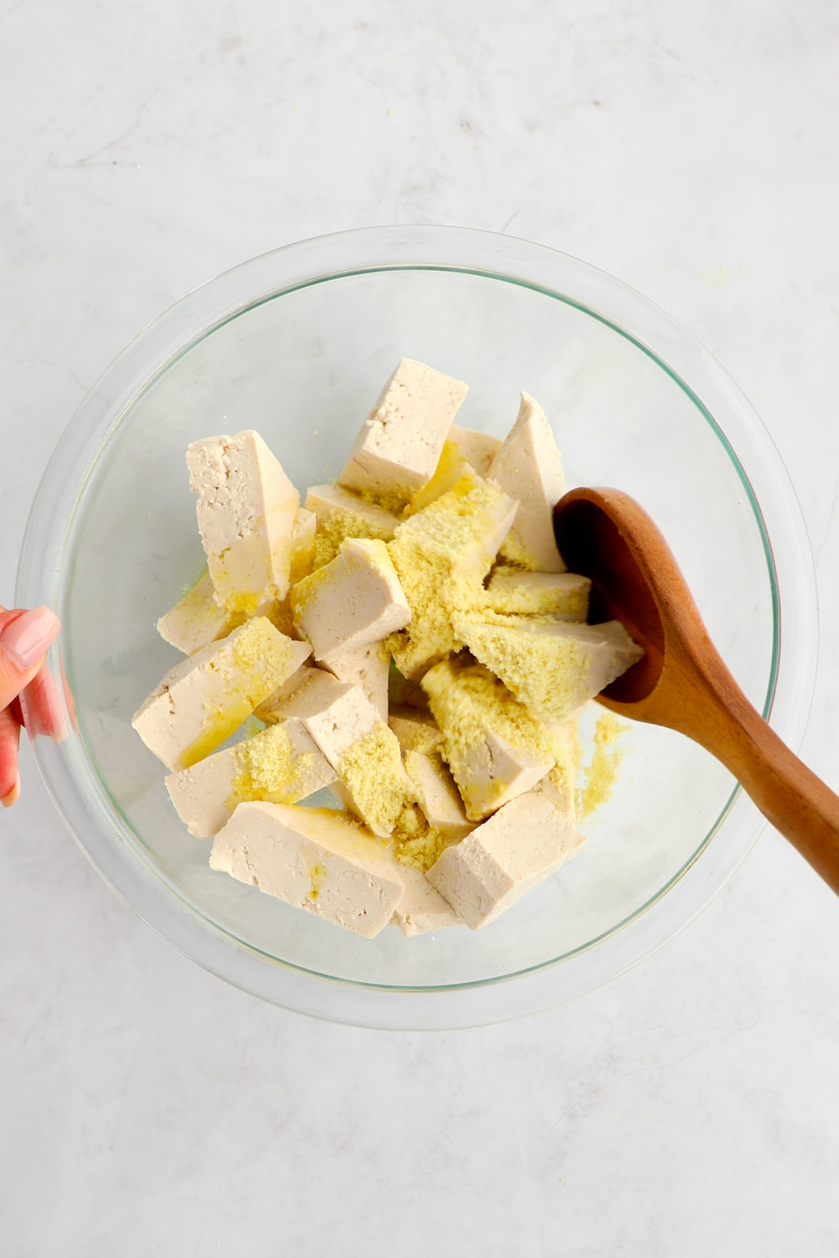 Sheet pan tofu in a bowl tossed with seasonings.