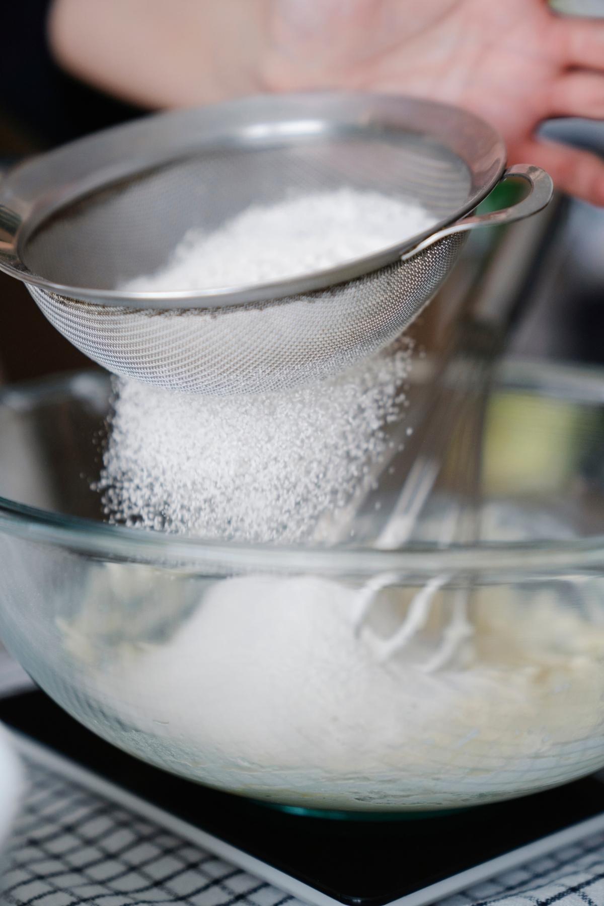 Flour being sifted into a bowl.
