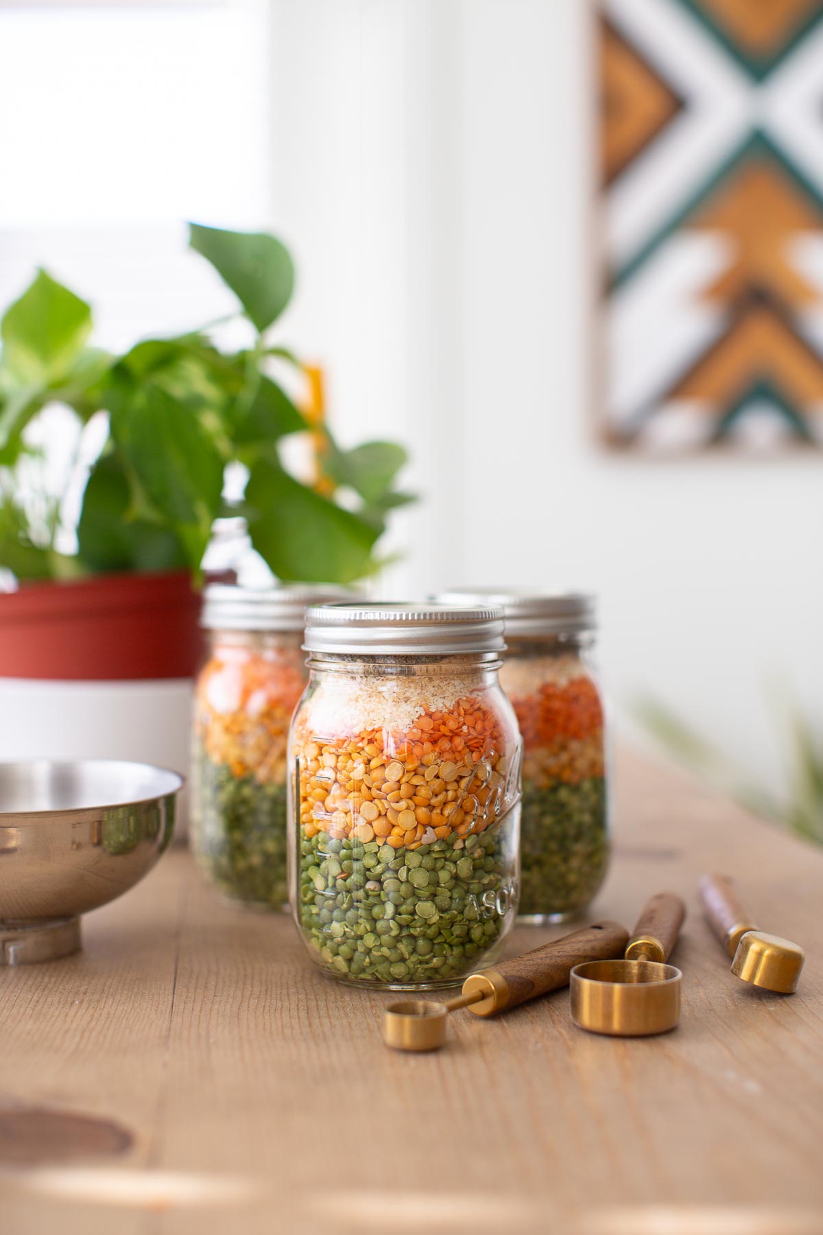 Jars of vegan soup mix with dried lentils, peas, and seasonings ready for meal prep.
