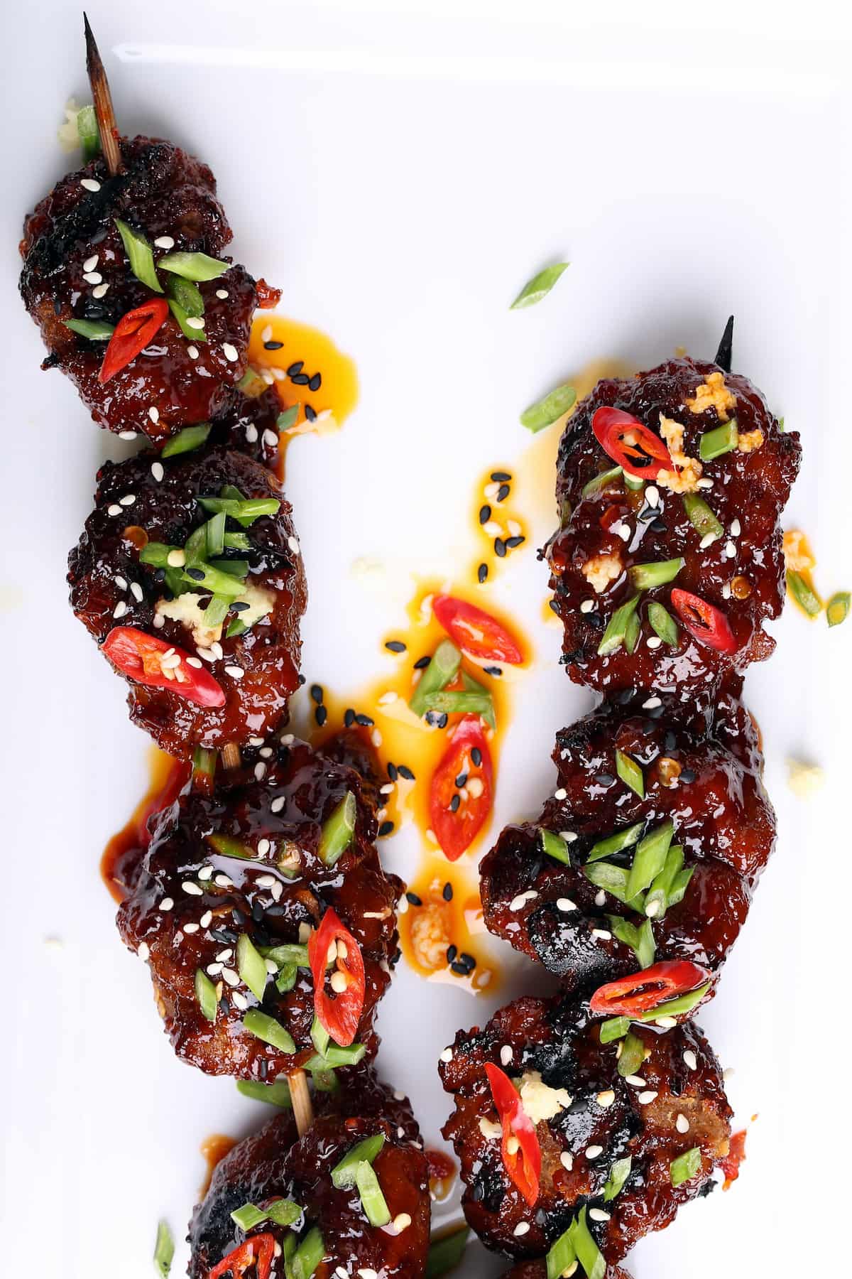 Spicy sambal seitan skewers grilled and garnished with fresh herbs—flavor-packed vegan BBQ recipe.