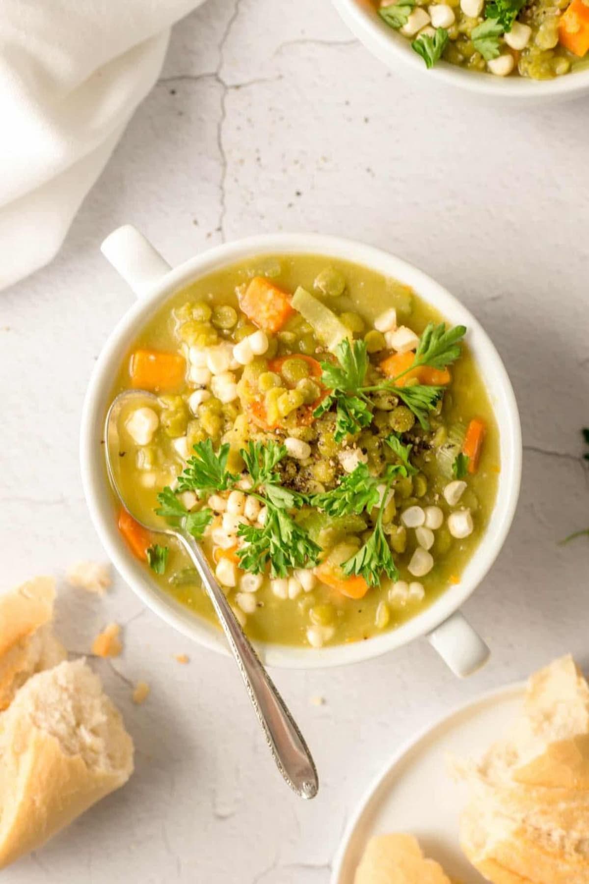 Vegan split pea and sweet potato soup in a bowl with a rich golden broth.