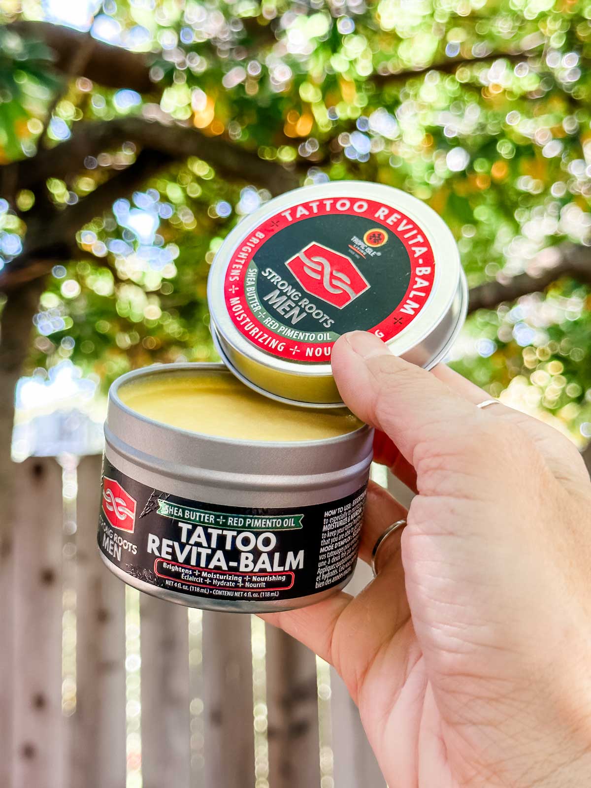 A tin of Strong Roots brand vegan tattoo balm.