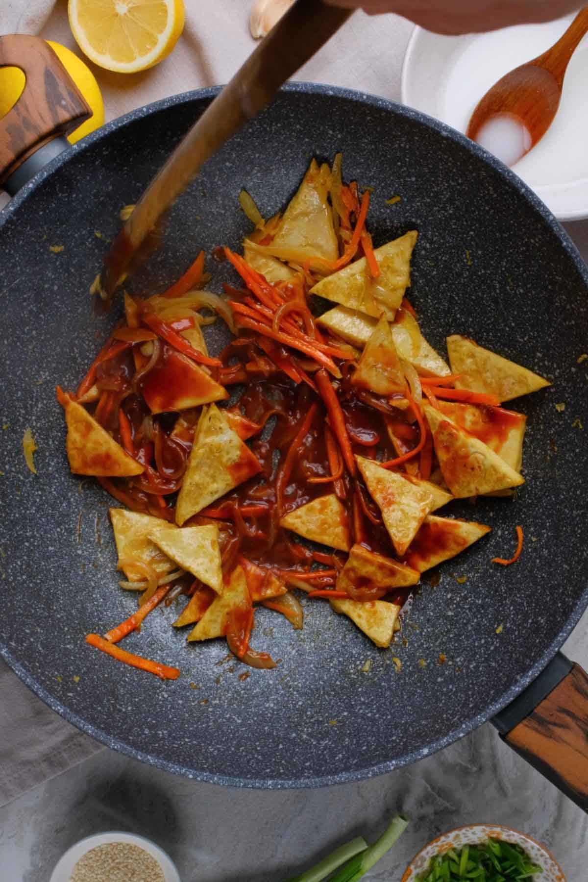 Tofu and veggies in a skillet.