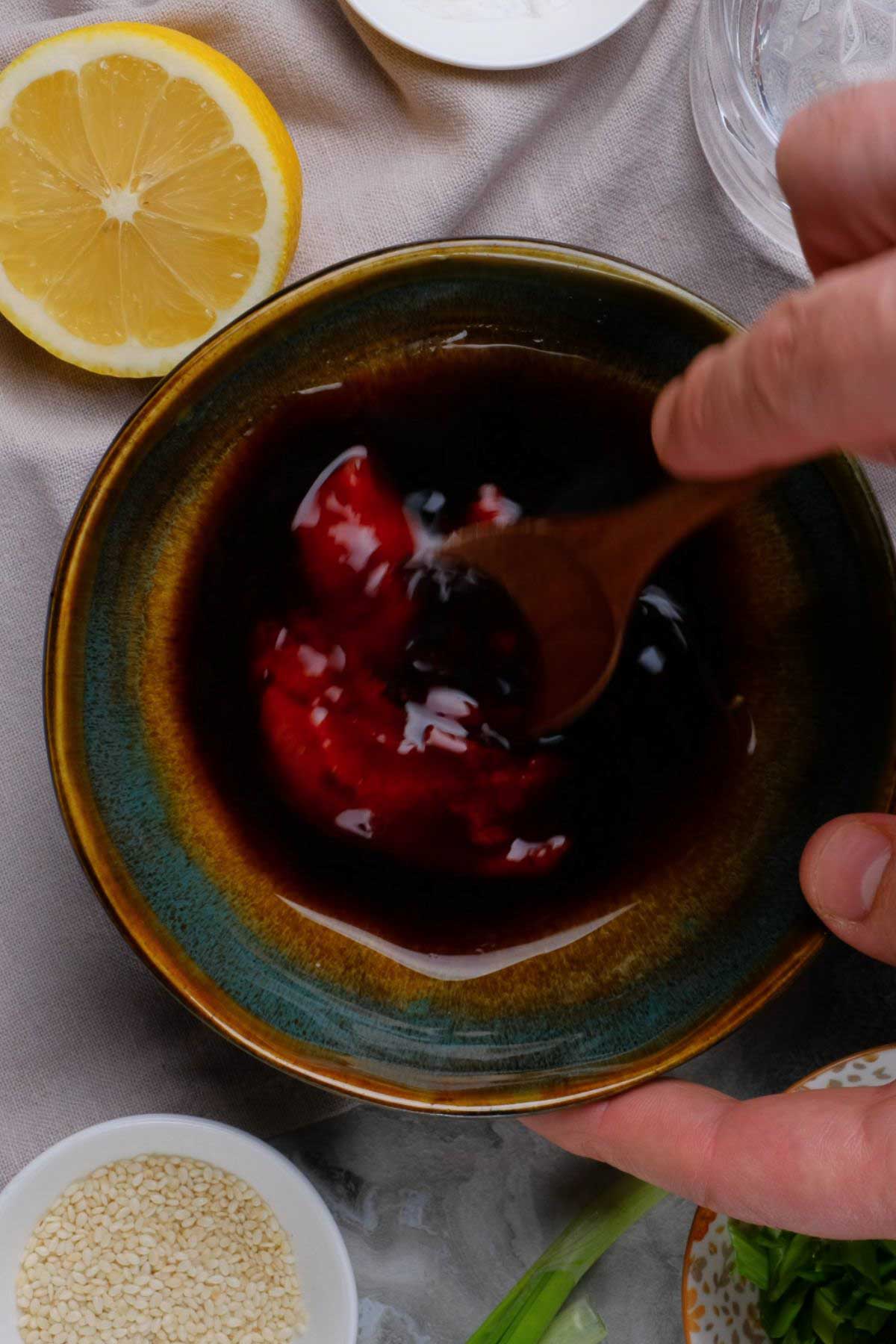 Sweet and sour sauce being prepped in a bowl.