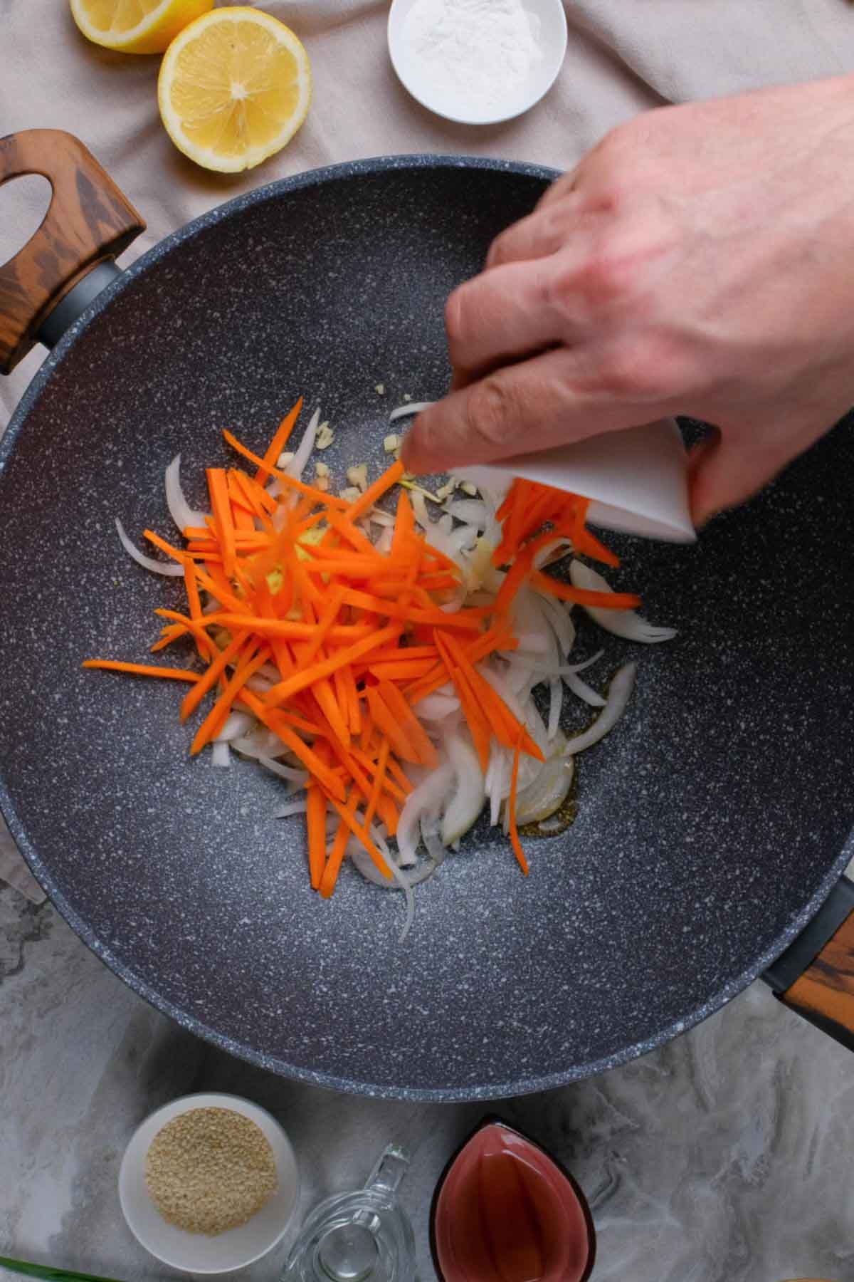 Carrots, onions, and ginger in a skillet.