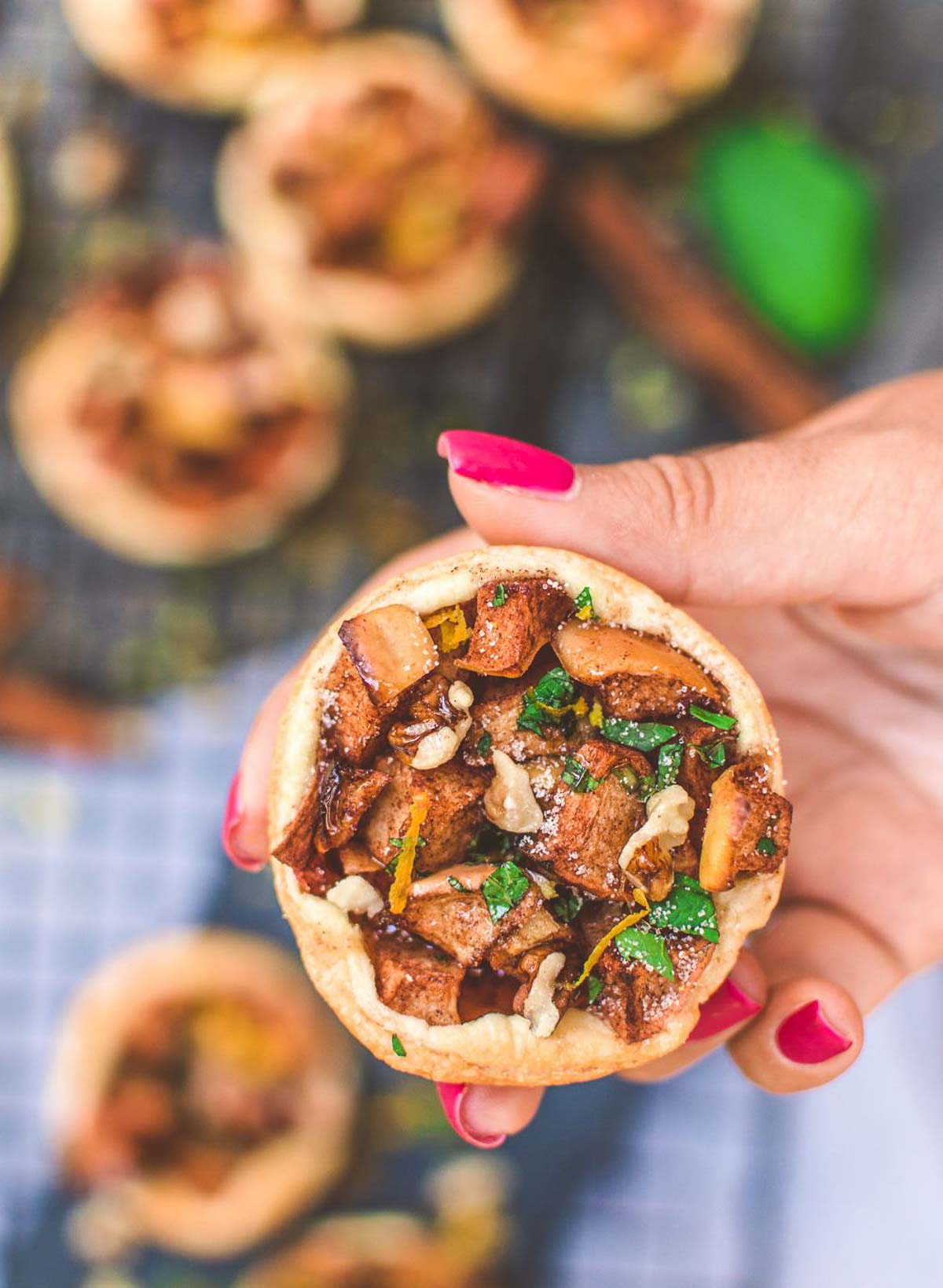 A hand holding a vegan apple strudel.