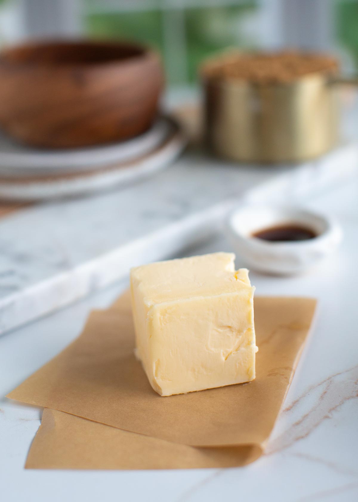 A block of vegan butter on parchment paper.