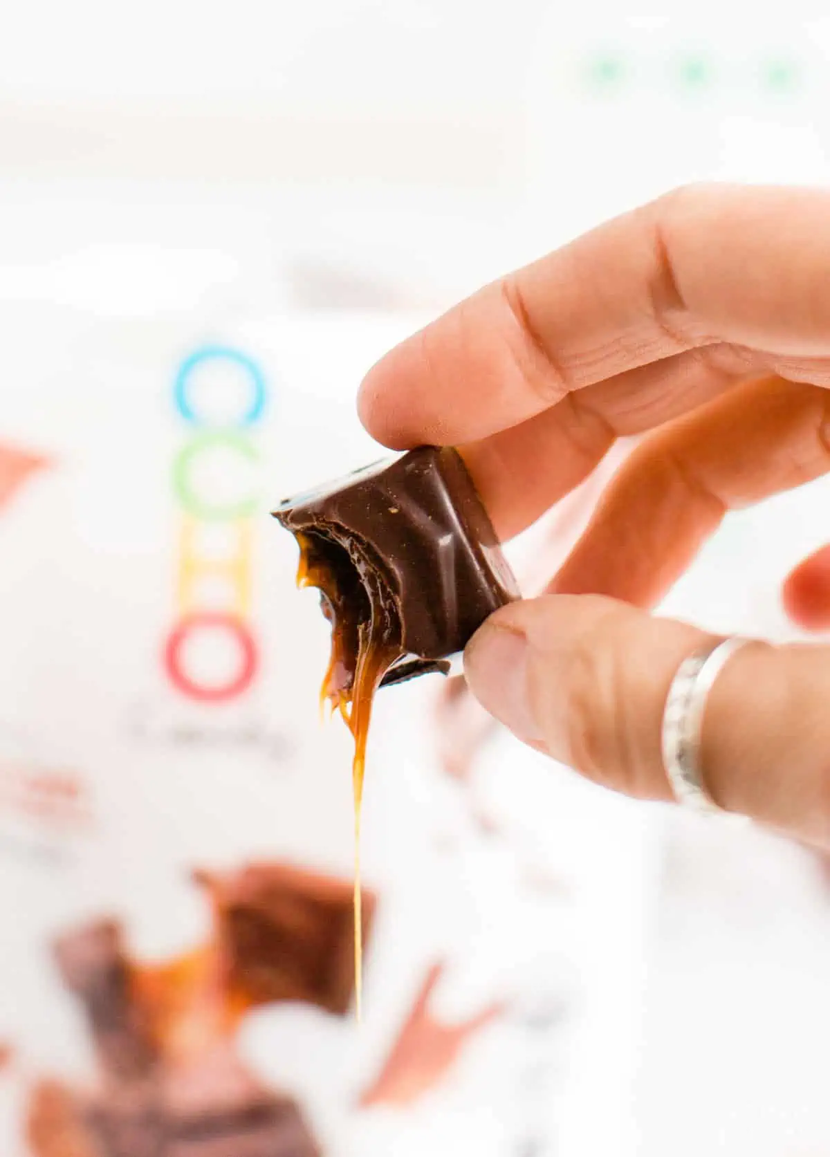 A piece of gooey dairy-free chocolate with gooey caramel in the center.
