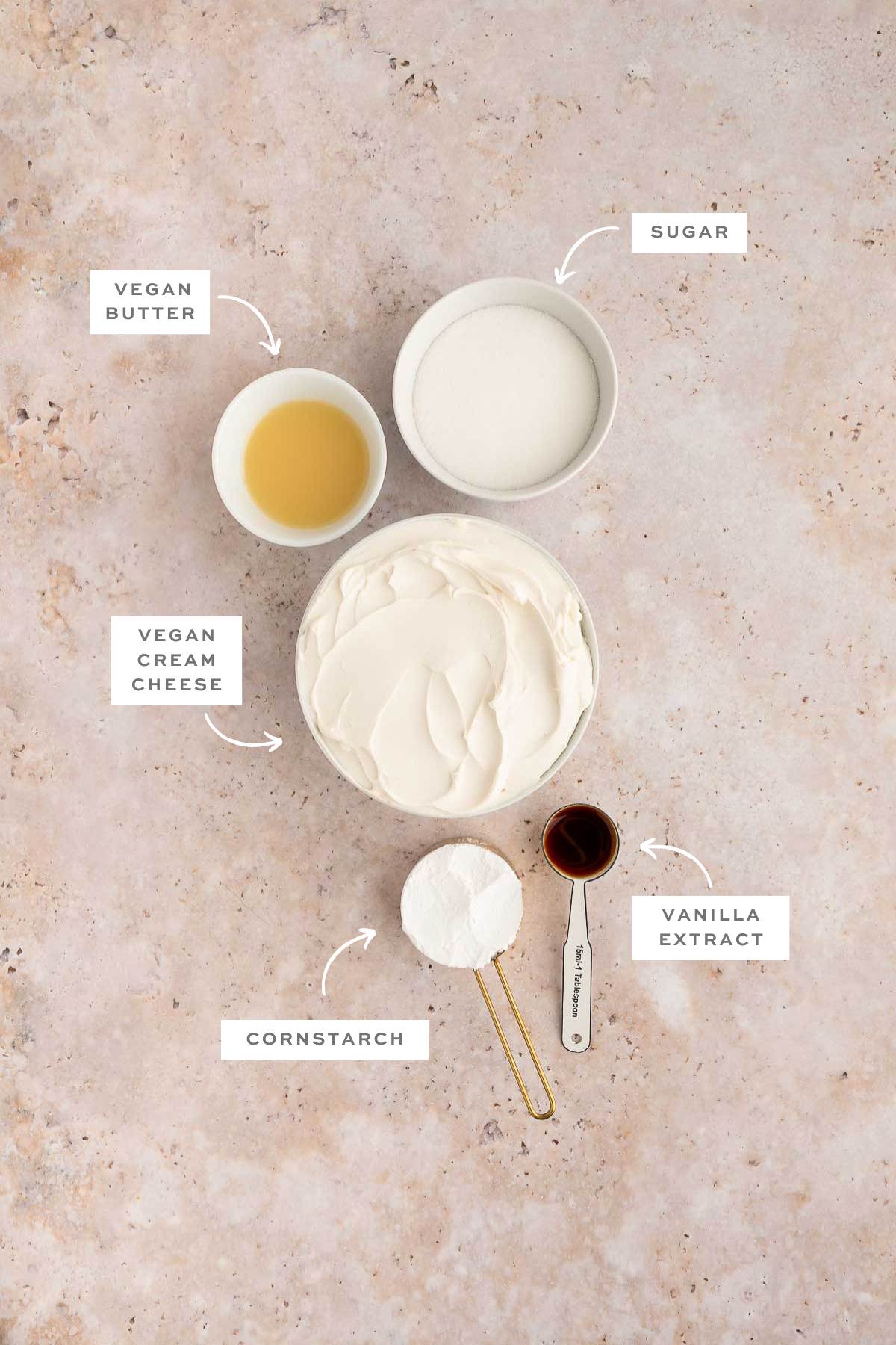 Gathered ingredients for this vegan cheesecake recipe in individual bowls with labels.