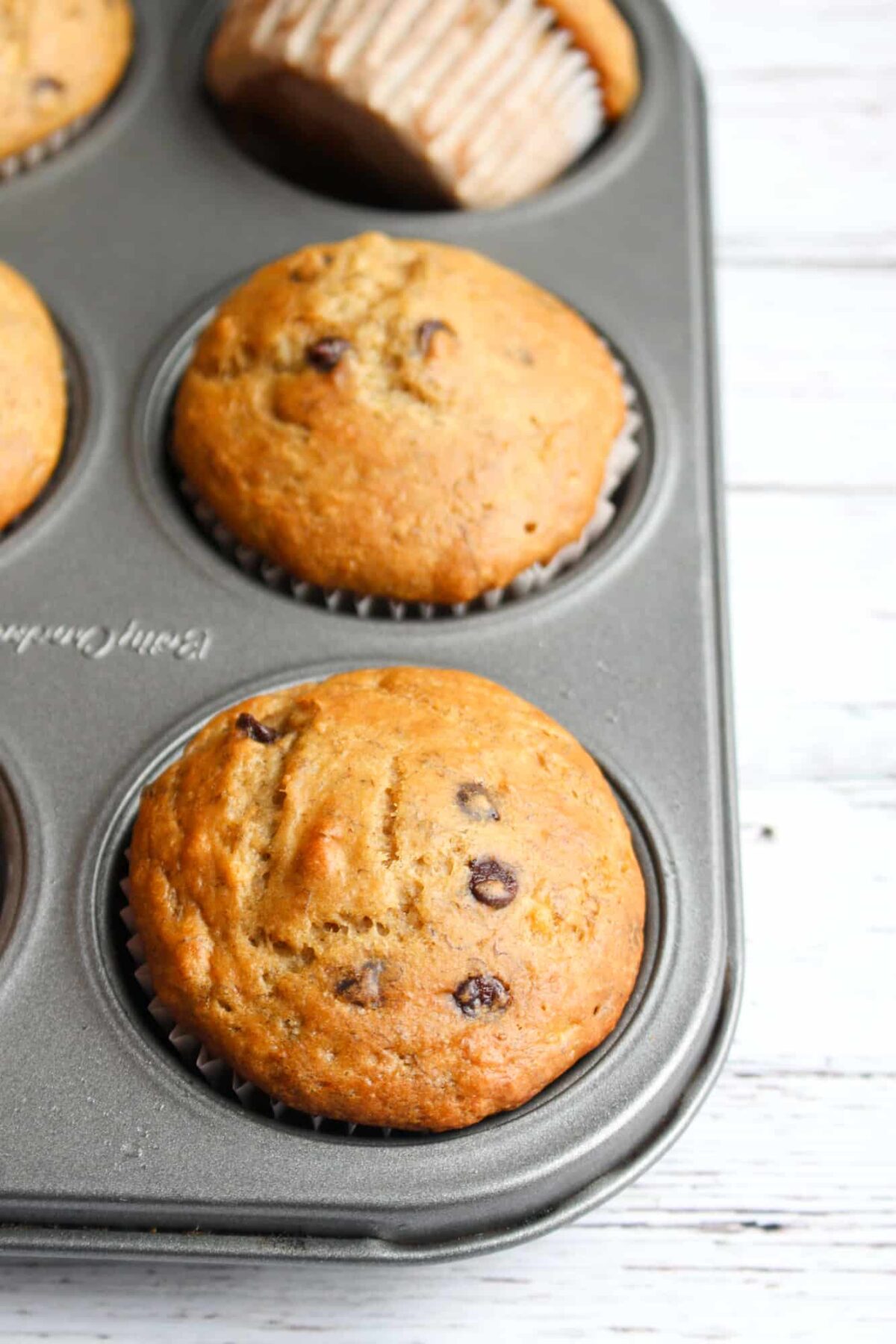 Vegan chocolate chip banana muffins in a baking tin.